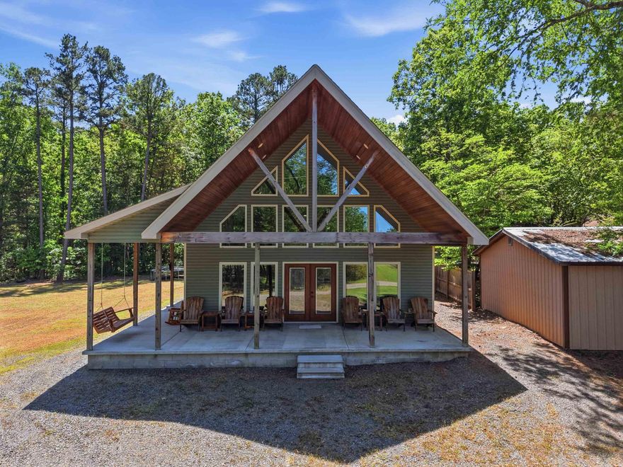 Come enjoy this spacious 3  bedroom Cabin just a short and easy 200' walk to the lake.  Featuring vaulted ceilings and stained concrete floors, this home is currently set up to sleep 12 guest.  Relax on the expansive wraparound porch that spans two sides of the cabin, offering plenty of space for outdoor entertaining and enjoying the peaceful surroundings.