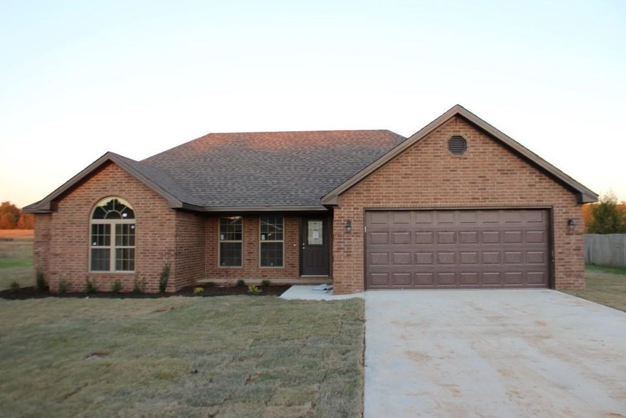 This is a fantastic new construction home with four bedrooms and two bathrooms. The brick exterior makes for easy maintenance. The inviting family room has a fireplace and acid stained concrete floors that extend into kitchen and dining area. Great kitchen with abundant stained cabinetry and stainless steel appliances. Master suite features a tray ceiling, neutral carpet, double vanities and a jetted tub. Additional amenities include a two car garage, laundry room, covered porch and landscaping.