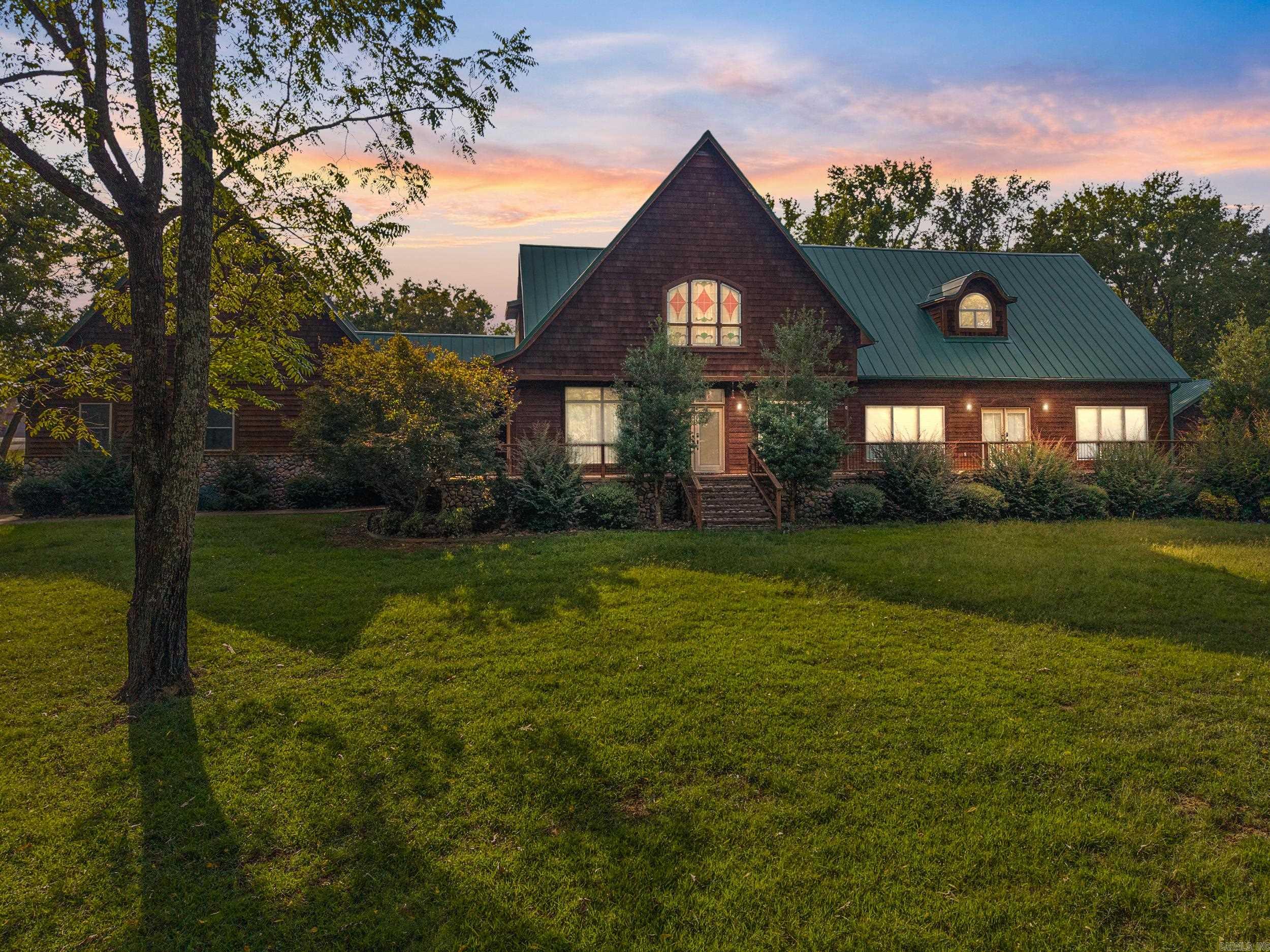 Luxury Living on 3 Ac with a shop! Discover this impressive lodge style 5K+sf estate offering the perfect blend of elegance, comfort & functionality. Situated on 3.09 ac, this property offers 5BR, 4.5BA & multiple living areas. Has two Primary bedrooms (one upstairs, one downstairs) & two optional living areas. The heart of the home boasts a spacious kitchen opening to 2 living rooms & 2 dining areas with tons of natural light from the East facing windows. You will love the cat walk/balcony overlooking the downstairs. In addition, it offers large bathrooms, walk-in closets, a bonus room & incredibly peaceful views of a beautifully rolling property. A rare highlight of this home is the safe room as well as basketball court inside the enormous garage providing endless recreation & fitness opportunities right at home! For hobbyists, entrepreneurs or those needing extra storage the 32x50 shop is incredible and a must see! There is over 1000sf of porch/patio space. This 3 acre property is beautiful, manicured, and has room to garden, play, or simply relax. This one-of-a-kind property provides upscale living with unique decor perfect for a lifestyle that values both! Agents see remarks