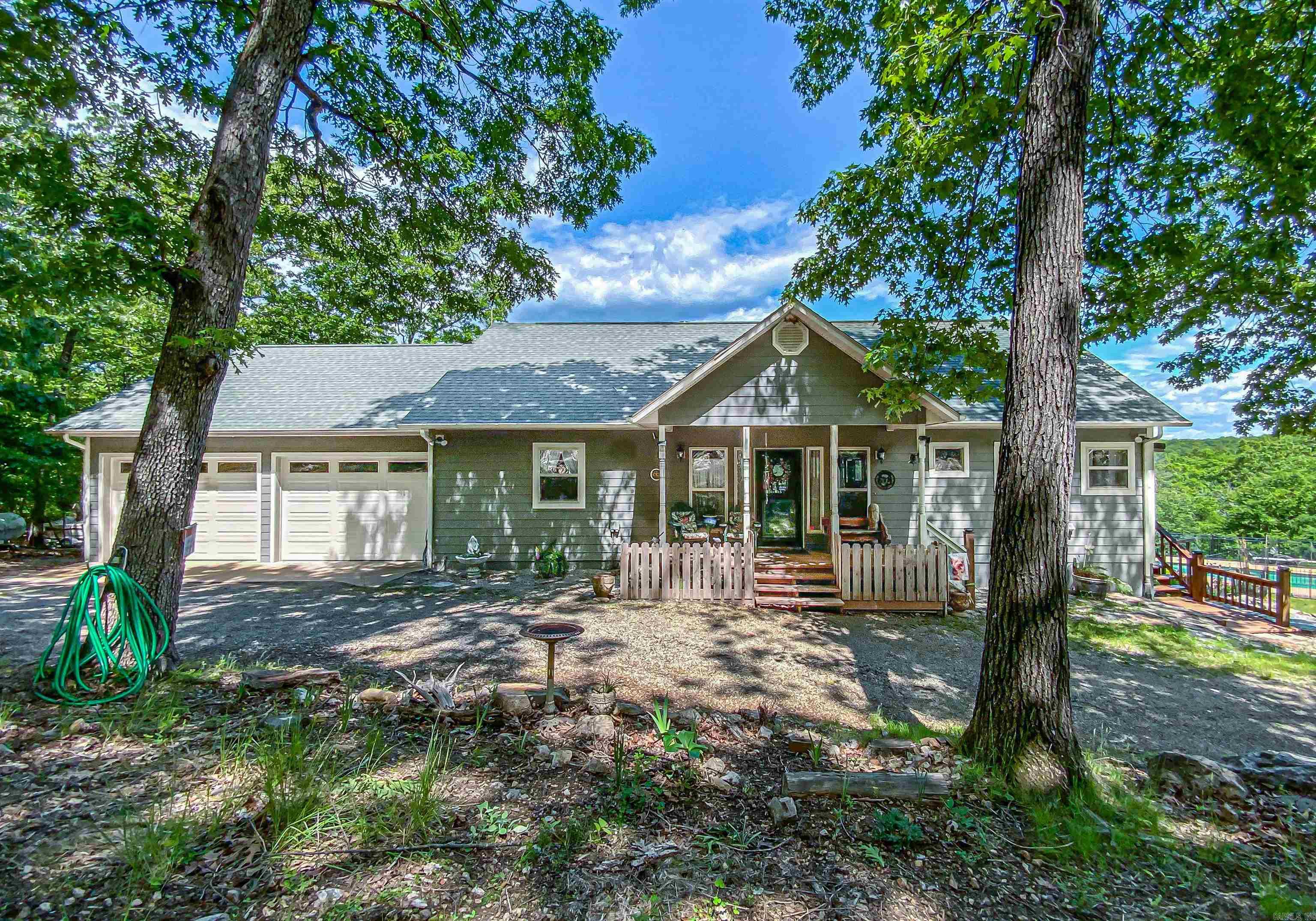 Home with panoramic views of Bull Shoals Lake from almost every room and even while swimming in the salt water inground pool. Beautiful stone fireplace you can see from kitchen and living room. Open floor plan, covered deck overlooking the pool and lake. Kitchen had a makeover in 2022 with custom cabinets and granite countertops along with stainless appliances including ice machine and trash compactor. Eat in bar and separate dining room overlooking the views. Master suite with walk in closet bathroom with double sink vanity and separate tub/shower. Basement has two bedrooms with jack & jill bath just off the family room with wet bar for entertaining. Pole barn for storage and separate building with 1 bed, 1 bath apartment w/efficiency kitchen and shop with 16’ overhead door. RV parking with hookups, fenced back and side yard, circle drive and two car attached garage. All on 4.7 acres mostly wooded. One mile to community airport and half a mile to boat slip in community dock.