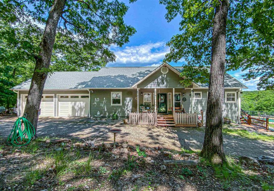 Home with panoramic views of Bull Shoals Lake from almost every room and even while swimming in the salt water inground pool.  Beautiful stone fireplace you can see from kitchen and living room. Open floor plan, covered deck overlooking the pool and lake. Kitchen had a makeover in 2022 with custom cabinets and granite countertops along with stainless appliances including ice machine and trash compactor. Eat in bar and separate dining room overlooking the views. Master suite with walk in closet bathroom with double sink vanity and separate tub/shower. Basement has two bedrooms with jack & jill bath just off the family room with wet bar for entertaining. Pole barn for storage and separate building with 1 bed, 1 bath apartment w/efficiency kitchen and shop with 16’ overhead door. RV parking with hookups, fenced back and side yard, circle drive and two car attached garage. All on 4.7 acres mostly wooded. One mile to community airport and half a mile to boat slip in community dock.