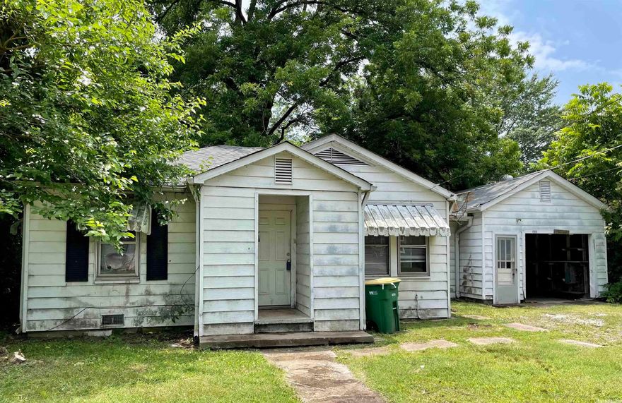 Calling all FIRST time home buyers and investors! NEW roof put on this home: March 2023. Tenant has moved out and now is the time to make this three bedroom and one bath home your own. Enjoy a large kitchen. Enclosed back porch with laundry area. Attached garage with plenty of built in shelving and rails if you wanted to add back a garage door. Original crystal doorknobs. Close to the interstate, schools and shopping. Call today for your private showing. Being sold as is. **See Agent Remarks**