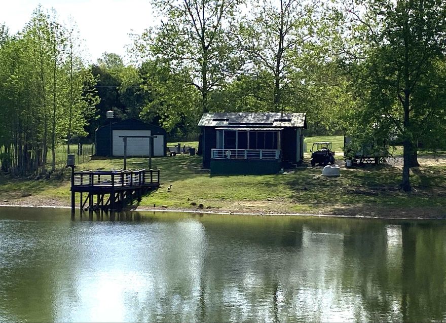 Discover a versatile country property featuring two fully stocked ponds including one large scenic pond, Fully developed setup ideal for homesteading, rental income or multi family living. The land includes three cabins, a spacious shop and a greenhouse, offering excellent flexibility for work or storage and year round gardening.   Agricultural features include established Muscadine vines, mature Pear, Cherry, Plum Trees as well as a Moringa tree, and fenced suitable for goats or other farm animals. the layout provides open space, privacy and multiple use option perfect for small farming, retreat property or investment.This unique property also has two wells, combined natural with functional improvements creating a ready to enjoy rural lifestyle. (There is Three cabins) Showing must be scheduled and approved to enter property. SEE agent Notes