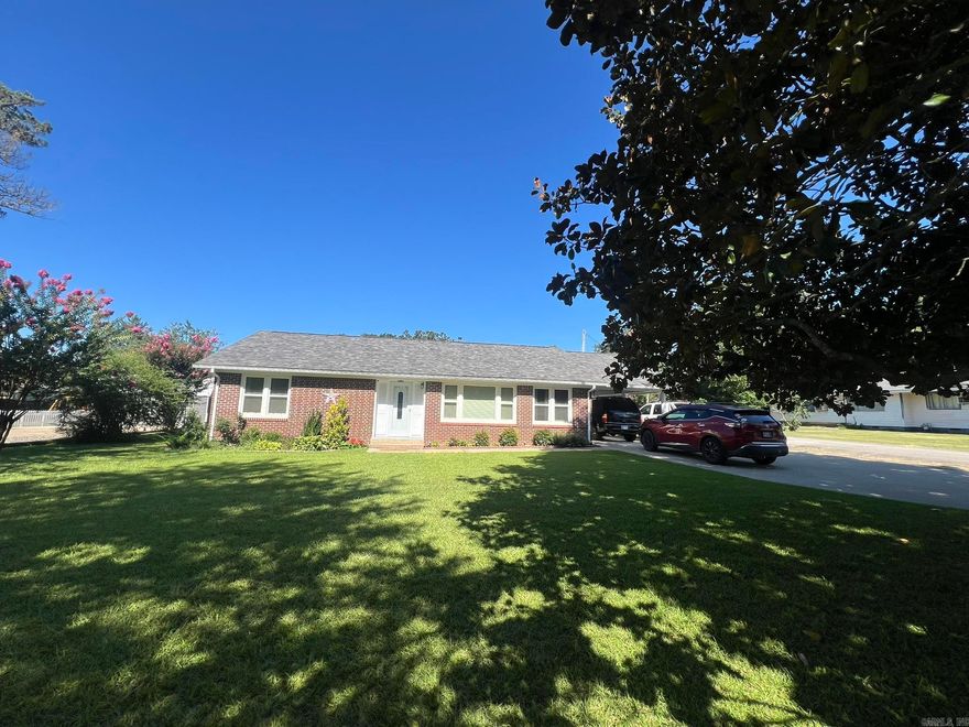 Spacious home with beautiful hardwood floors! Not to mention the extra landscaping and a backyard/patio area that offers the perfect space for relaxation - you must see this home today! Large living room features beautiful plank-wood paneling, and the kitchen has been updated with granite countertops. New vinyl windows, 3-ton HVAC is only two years old, and there is a brand-new roof put on in 2025. Three large bedrooms all feature hardwood flooring and ample closet space. The bathroom has also been updated. The bathroom, kitchen and laundry all feature tiled floors. Venture outside to the large covered patio, and enjoy the seating areas under the gazebo featuring a fire pit. The backyard is completely fenced, and the front yard has a gorgeous, large magnolia tree. Plenty of parking space on the concrete drive with carport, that fronts on two streets. Priced to sell - this is one you don't want to miss!