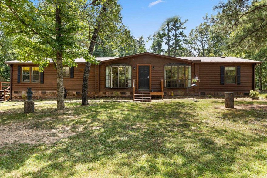 This beautifully renovated 3-bedroom, 2-bathroom home is ready for you to move in and enjoy. The property features a new roof and carpet installed in 2022, and more recently, it has all-new flooring and fresh paint throughout. The kitchen and bathroom boast new cabinetry along with updated Formica and Quartz countertops. You will love the custom-built walk-in shower and jacuzzi tub.   The exterior includes freshly painted and sealed front and side patios, a large outdoor shed for ample storage, and an oversized metal carport that is 30 feet deep with room for an RV if needed. Additional features include gutter guards, a chimney that was cleaned in winter 2023, and a septic system that was pumped in late 2022.   A transferable 3-year home warranty is included, along with a riding mower and  that will remain with the property. Located just 15 minutes from all essential amenities, this home is perfectly situated to offer the quiet, serene, and private lifestyle that Arkansas has to offer.