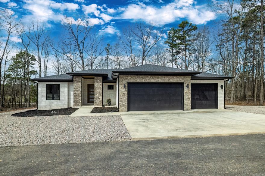 New construction featuring numerous builder upgrades.  Fall in love with this beautiful home.  From the moment you walk through the 10 foot glass front door you will be impressed with the amenities of this home. Great room with gas fireplace and designer surround shelving and cabinetry for storage and beauty.  Kitchen features a large solid island, walk in pantry, lovely ceramic backsplash, more than ample counters and cabinetry, sink is located on side wall with a view of the wooded area.  Dining area boasts a stunning light fixture in a very spacious area.  Primary suite has lots of light, large bath with oversized shower and closet. Two guest rooms share bath with dual sinks, large shower tub combo. Each guest room has large windows and spacious closets.  Hot Springs Village is a 26,000-acre gated community with 11 lakes, 9 golf courses, white sand beach, hiking trails, pickle ball, fitness center, indoor and outdoor pool, tennis and SO MUCH MORE. One time POA buy-in fee $2000 due at closing.  Taxes are on vacant land