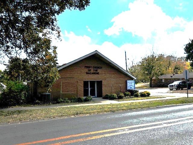 Church building with three additional parcels. Church building has 5580 of heated & cooled square feet. Entering from the main 2nd Street entrance, there is a small lobby with two restrooms, with entry into the beautiful central sanctuary with seating in place. The sanctuary features wooden beams and wood ceiling, includes a baptistry just behind the platform. Seating estimated between 125-150 in sanctuary. Located behind the sanctuary is the two level educational areas. The upper level features a large open area with five classrooms. In the lower area are three additional classrooms, one half & one full bathroom, large open area that opens to a small kitchen area at one end. The property is zoned R-2 which includes a total of 4 parcels with parking areas on two small connected lots just across Plum St., and additional parking lot just to the rear of the church main lot which connects to Pruett St.. The property is located just North of downtown Paragould. Priced to sell and being sold "as-is".