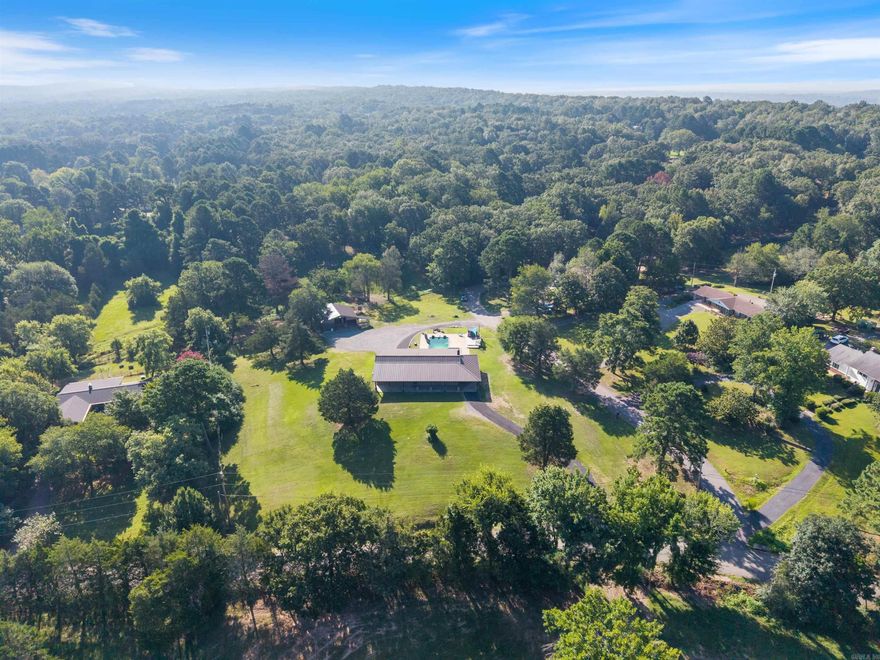 This newly renovated home is in pristine condition and loaded with quality craftsmanship and immaculate design. The property is almost 4 acres and comes with a barn, pond, and pasture for horse owners. It boasts a large L-shaped saltwater pool and the back porch extends the width of the home perfect for entertaining. The upper level has its own separate entry and showcases a large open concept living/dining/kitchen with an island covered in custom tortoise shell granite. The lower level of the house is also an open concept with a large living/dining/kitchen area. The oversized enclosed garage allows for parking multiple vehicles and room for workspaces. The detatched barn added in 2020 has ample space for storage and room for RV parking all enclosed. This incredible homestead is ideal for families in need of in-law quarters who need a separate living space. Each floor is fully equipped with its own full kitchen and laundry areas. This home is the best of both worlds offering private country living with Conway Corp utilities while affording easy access to the interstate and city amenities!