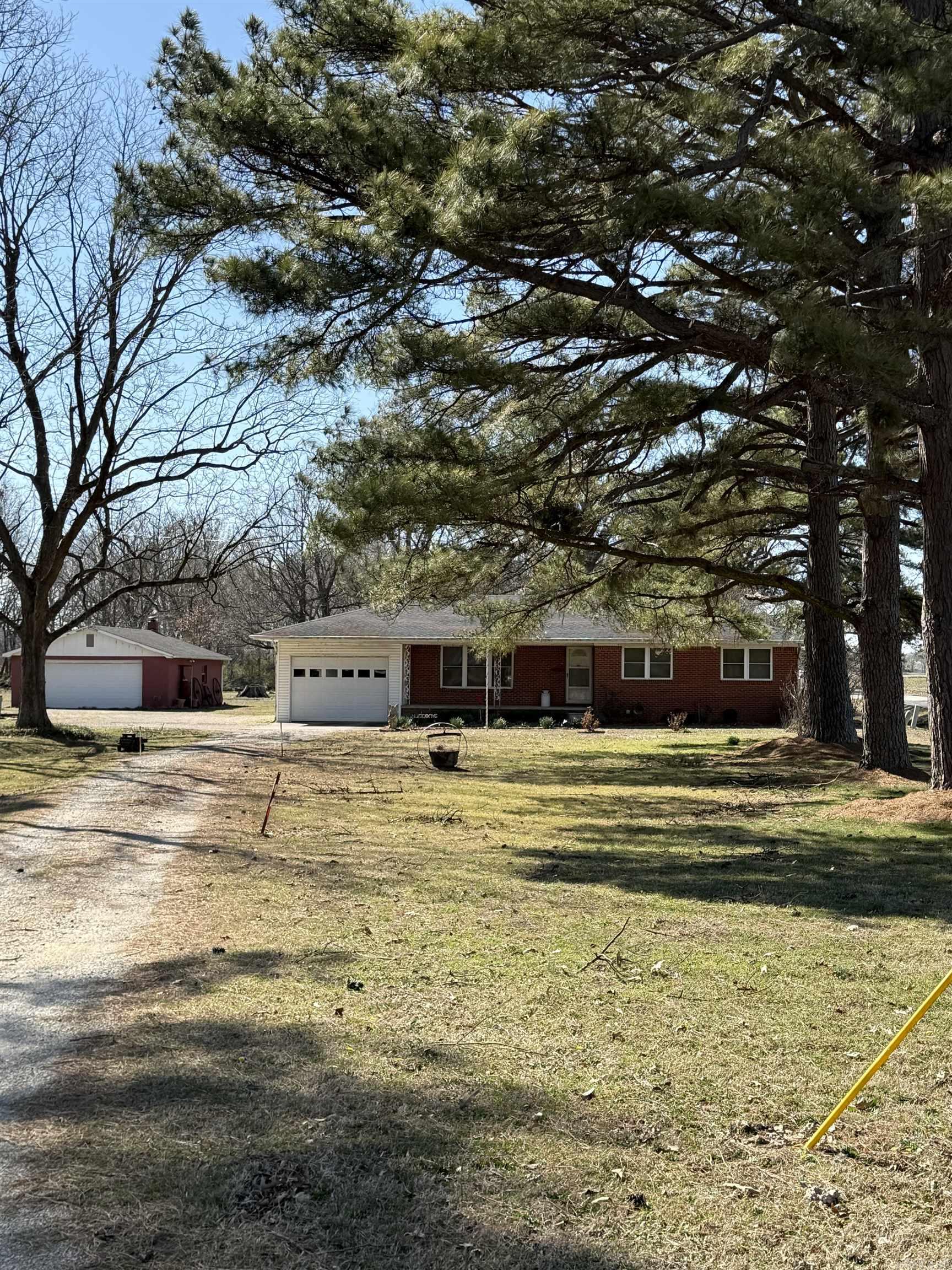 Discover the potential of this unique property with acreage and dual shops. Introducing an extraordinary opportunity, conveniently located just 1/4 mile outside city limits on a paved road. Nestled on approximately 3 acres of land, this property offers the perfect blend of tranquility and accessibility. While the cozy 3-bedroom, 2-bathroom home provides a comfortable living space, with large deck overlooking beautiful it's the two expansive workshops that truly make this property shine. With both a large 30 x 50 shop that's tall enough to house farm equipment or an RV, and an additional two-car workshop, you'll have more than enough room to bring your ideas to life and store all your equipment. Property also has a lean to that will store lots of wood or extra equipment. Circular driveway with plenty of parking. This property is an absolute must-see. Don't miss your chance to own a piece of paradise.