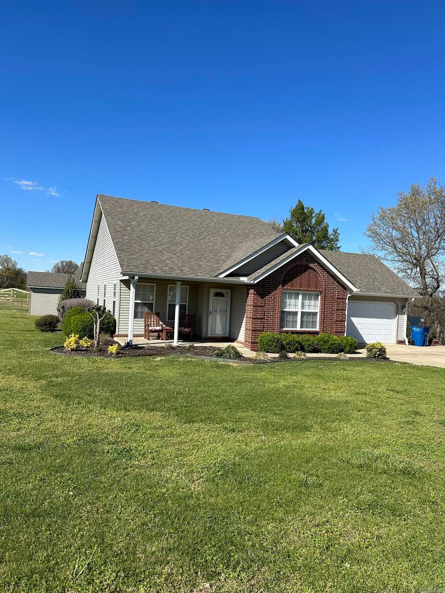 Spotless, move-in ready updated home resting on lot 33 with corner lot 31 of North Ridge Subdivision included. House features an open floor plan with real hardwood flooring in open areas and down halls, two baths have ceramic title, and bedrooms new neutral carpet.  Much storage in house with spacious closets featuring custom shelving, pantry storage, and many beautiful wooden cabinets in kitchen, ample room for a table and chairs.  A two car garage is attached to the house.   Another garage unit is located behind house with electric to it.  Features an overhead door, large work bench and storage area.  Between it and the back of house are large wooden raised beds complete with climbing treliss for plants.  Has gas hook up outside for a whole house generator.  Roofs were replaced June 2023, York heating/ac unit is recent. City sewer, and all electric house is well insulated for low electric bills.  A must see!  Call agent for instructions to show.  This one is located conveniently but with a fenced field behind.  City livingn with country feel.  WILL NOT LAST LONG. 870-240-6146