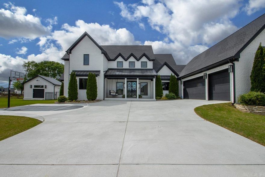 If LUXURY WITHOUT LIMITS is what you've been searching for, stop scrolling now! This stunning modern estate offers the rare opportunity to enjoy a premier lakeside location with total independence, as it is uniquely exempt from all POA dues, restrictions, and special improvement taxes!  Situated on a sprawling nearly half-acre lot directly across from the lake, this 3,500+SF contemporary masterpiece has endless features, starting with a basketball half court when you pull up! There are Four spacious Bedrooms and 3 Full Bathrooms with walk-in tile showers. The home's interior features designer lighting and high-end finishes, Gorgeous plantation shutters and a dramatic floor-to-ceiling brick fireplace. Love cooking? You will love the show-stopping kitchen with a massive island, gas range, wall oven, ice maker and an oversized pantry. The primary suite is a true sanctuary with dual walk-in closets, floor-to-ceiling storage, and a spa-like bath where a clawfoot tub sits elegantly inside a fully enclosed tile shower.  If you spend time outdoors, this home offers 2 distinct patios, one featuring a gas firepit and a fully fenced yard. Dont forget the peaceful sunroom, 3 car garage & Shop!