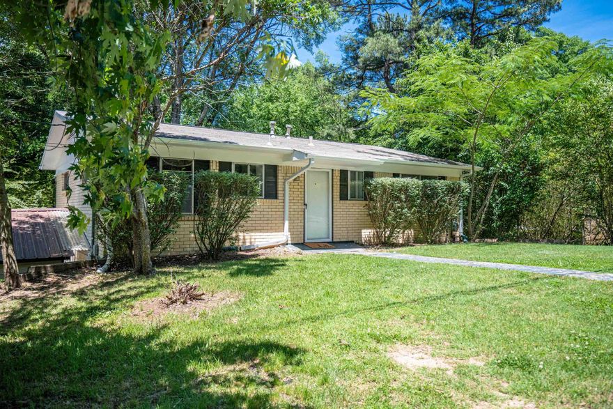 DON'T MISS THIS PEACH OF A SWEET HOME... freshly painted inside & out...ready for YOU! You will want to enjoy many morning coffee's and evening "how was your day" conversations on the covered deck overlooking a fully fenced backyard, complete with darling children's playground equipment as well as a covered storage shed. This all brick home features 3 good size bedrooms and 2 full bathrooms, along with a great living room overlooking the deck. Large open kitchen with lots of natural light has a breakfast bar that opens to the living area.  Great lower level living has an ensuite bedroom and ANOTHER living area offering options and space for everyone! AWESOME 35 FT LONG STORAGE ROOM that includes lots of built-in shelving & a small workshop. Newer double car carport covering. COURTHOUSE MEASUREMENTS INCORRECT...please feel free to measure