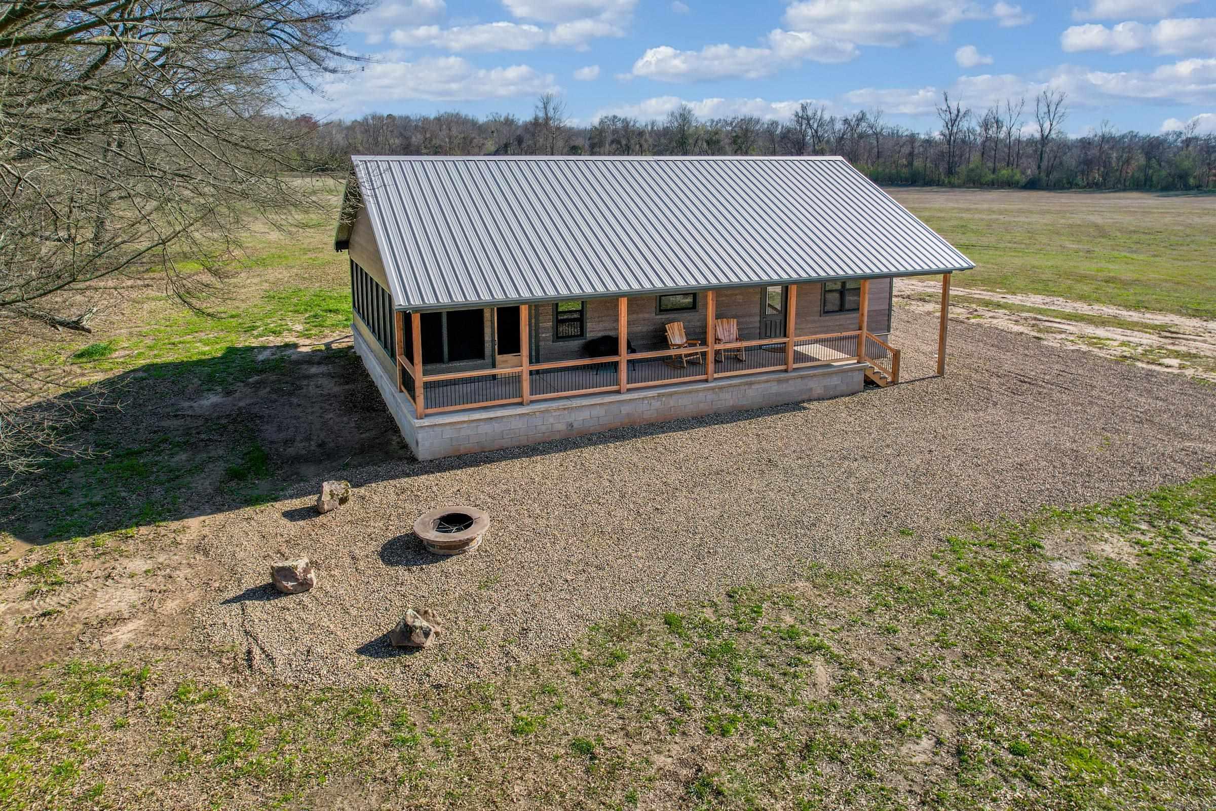 Situated on a peaceful 3.7-acre lot off of the banks of Little River, this 2 bedroom/2 bathroom house features 1,170 sq ft cooled. Additionally, the home is highlighted by a 369 sq ft front porch and a 360 sq ft screened in room overlooking Crappie Lake totaling 1,976 sq ft under roof, ensuring the perfect atmosphere for entertaining friends and family. A community boat ramp and access to the rock bar provides quick relief on a hot summer day. Whether the sun is shining or it's raining this property is the ultimate get-away for relaxation and making memories.