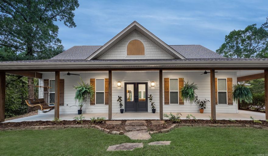 Nestled on a private, custom-built 4-acre homesite in a gated community bumped up to West Little Rock, this exceptional modern farmhouse showcases wonderful attention to detail at every turn. The open concept layout is introduced in the great room, featuring a dramatic vaulted ceiling with wood beams, a striking floor-to-ceiling Austin Stone fireplace complemented by built in shelving on either side, finished with beautiful ceramic wood-look tile flooring throughout. The luxury kitchen is a chef's dream, equipped with granite counters, high-end appliances, and a large island that flows nicely to the dining room. Your butler pantry leads into a second entrance off the laundry room attached to the garage. A dedicated office with stunning French glass doors, a sunroom with panoramic views through its ample windows, and a spacious master suite with a large walk-in closet and a custom-tiled shower provide ultimate comfort and luxury. Additional flexible space includes a large bonus room upstairs that could also be used as a 4th bedroom. Completing this picture-perfect property is an expansive wrap around porch. This home is truly one of a kind!
