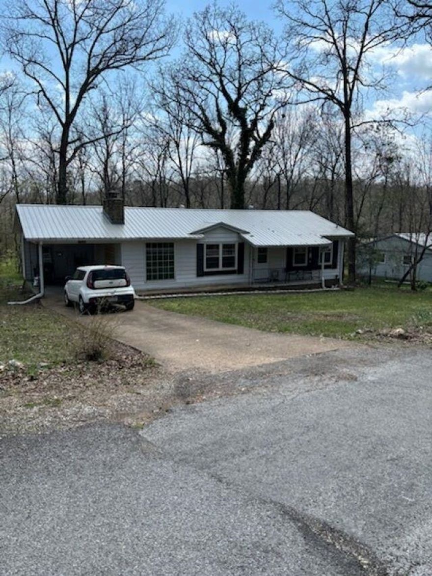 Nice move-in ready 2 bedroom bath and a half. Pretty laminate flooring with newer carpet in both bedrooms. It has central heat and air with anew fan installed this year. There is a site bult wood burning fireplace ready to snuggle up to on a cold winter night. The metal roof was put on in 2023 with many years of life left. Ample closet space for all your clothes and shoes! There is a sunroom enclosed, heated and cooled which is a great office area or additional space for entertaining! New refrigerator, sink and dishwasher. The newer washer and dryer stay and makes your move much sweeter! Wooded lot with a storage building in the back yard and a termite contract for your protection. Pretty flowers and plants adorn the front yard. When you purchase this home you will have access to 7 lakes, 2 award winning golf courses, a river, swimming pools, entertainment centers and all the luxury that high end properties have without the high end price! Make this yours today. Priced to sell at $129,900.00.