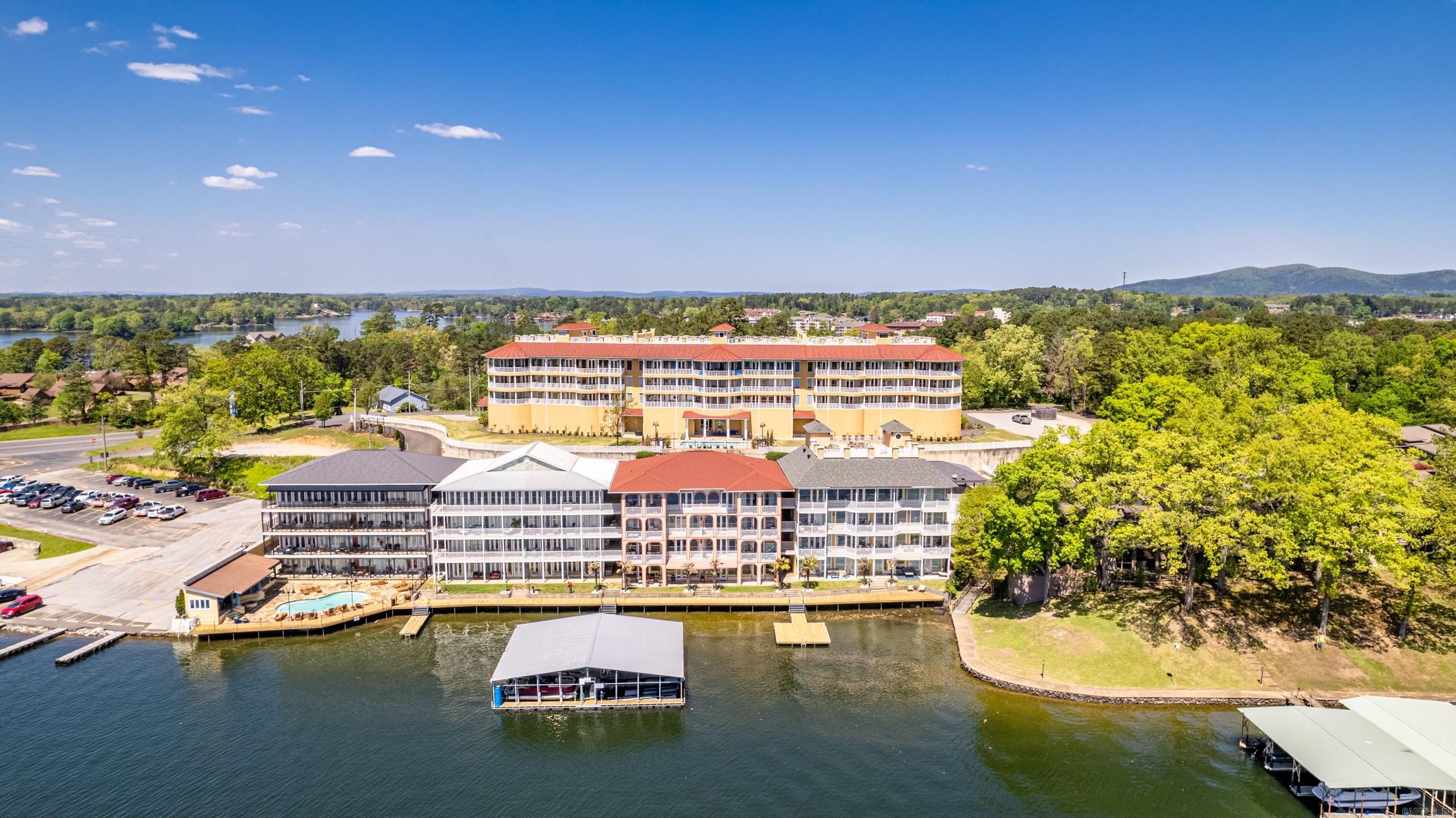Luxury condo in Hot Springs! Wake up to breathtaking views of Lake Hamilton and enjoy your mornings and evenings relaxing on the large balcony. The elegant kitchen features bone and black marble flooring, a new Cafe dishwasher and microwave, and a large island with plenty of storage. Entertain guests in the open living room areas, adorned with beautiful hardwood floors. The wet bar, complete with a new ice machine and wine cooler, is ideal for hosting parties. The condo also boasts updated paint, lighting, and drawer pulls throughout, giving it a fresh, modern feel. This unit includes a private storage unit as well. Seller holds Arkansas RE license.