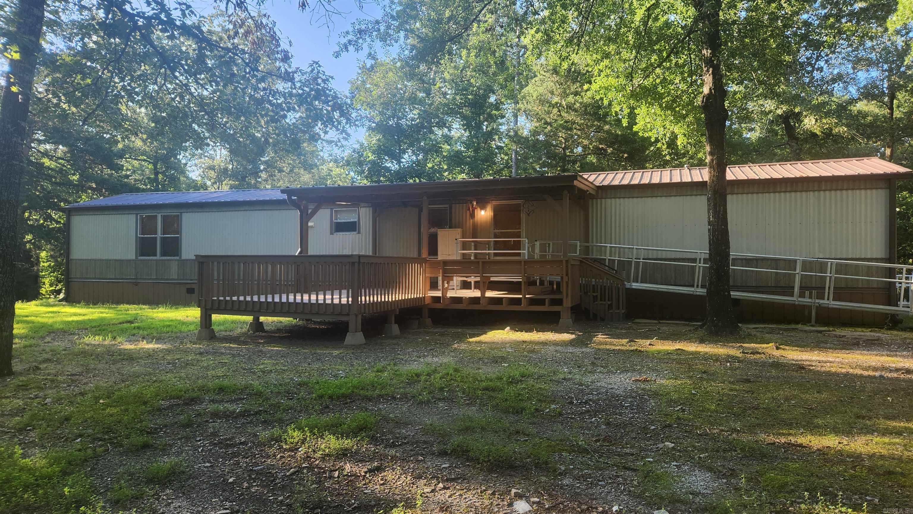 3 acres within walking distance of Lake Ouachita. No restrictions. 2006 Lexington single wide mobile 76x16. 3 bedroom, 2 bath. Handicap accessible with 2 metal ramps and shower. Central heat and air. Refrigerator stays. Porches on front and back. 30x30 metal shop with concrete floor, two 10ft roll up doors and a carport. There is an old survey. Home is on a well and has a septic. 20x20 metal carport. This was a vacation home for the sellers and not stayed in to often. It is quiet and fairly secluded.