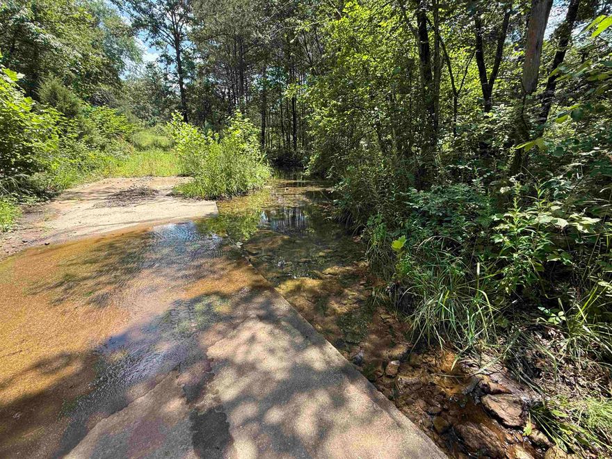 This beautiful 57-acre farm is nestled in the countryside, complete with a seasonal creek and stunning panoramic mountain views. The property features county road frontage on the south side and private road access along the west boundary, offering both convenience and privacy. Approximately 20 acres of level pasture have been maintained for Bermuda grass hay production, while the remaining 37 acres are wooded, making it ideal for a variety of agricultural or recreational uses. A prime building site offers incredible long-range views—perfect for your future dream home. Rural water and high-speed internet are available along the county road, adding modern convenience to this peaceful setting. Whether you're looking to build now or invest for later, this is a must-see property priced at just $199,500.