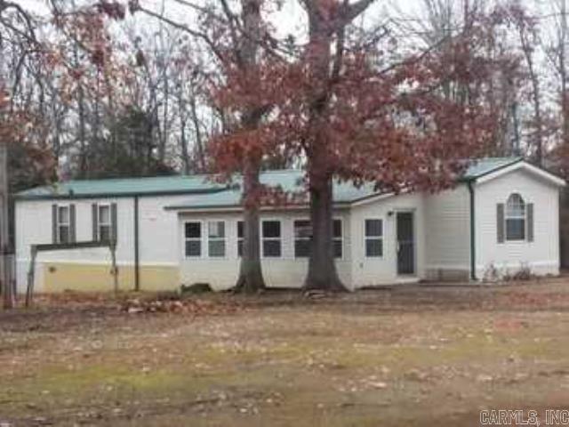 Lake Life Here We Come! Enjoy your time in this awesome, very desirable 5 acre location! The property features a 3BR / 2BA Mobile Home with an enclosed 264 sq. ft. Front Porch / Sun Room, perfect for a couple of twin beds to enjoy the night air in comfort or to have a sitting area to enjoy the outdoors without the bugs! Also has a 288 sq. ft. Deck on the back, perfect for your Morning Coffee while watching the Deer and Turkey! Appliances that stay with the property include Refrigerator, Washer and Dryer. Improvements to the Mobile Home also includes Metal Roof (2 yrs) Electric Water Heater (less than 10 yrs.) Need a SHOP for your water toys? It has that too! 32' wide and 40' long (1280 sq. ft.) of space with Two Overhead Doors and some cooking equipment for those Big Fish Fries! The Existing Boats (1-Ski Boat 1-Fishing Boat) could be bought as well. The 5 Acres is mostly wooded but could be cleared off for other projects! Only a little over a Mile to the Lake to the launching area at Hand Cove. (That's only minutes away from the water!) Buy this Beautiful Property and you're All Set! Call your favorite agent to see this property today! To be sold "As Is". (See Agent Remarks)