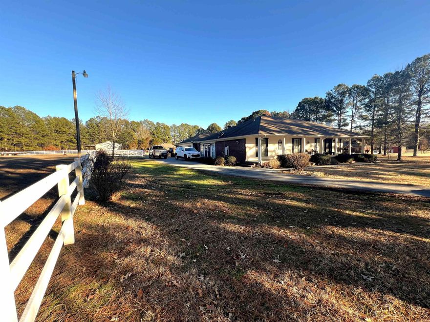 Come see this amazing home! A beautiful house on 3.16 acres with a barn and fencing for horses! Enjoy the very charming front porch that spans across the front of the house Vaulted ceilings in the kitchen and living room. No carpet, hardwood flooring except in bathrooms. Formal living room with a fireplace is being used as a dining room & office, huge kitchen with lots of granite countertop space and stainless steel appliances, a bonus space being used as a den and it has 2 closets and a full bathroom, and a very large dining room that has french doors leading to a pergola covered deck. The primary bedroom is apart with french doors leading out to the deck, and has 2 closets and a bathroom with a jetted soaking tub! Backyard with white picket fence. Oversized 2 car garage that has plenty of extra space for storage and a work bench! The barn has stalls for animals, lots of storage area, water & electricity! Refrigerator in the garage does not convey.