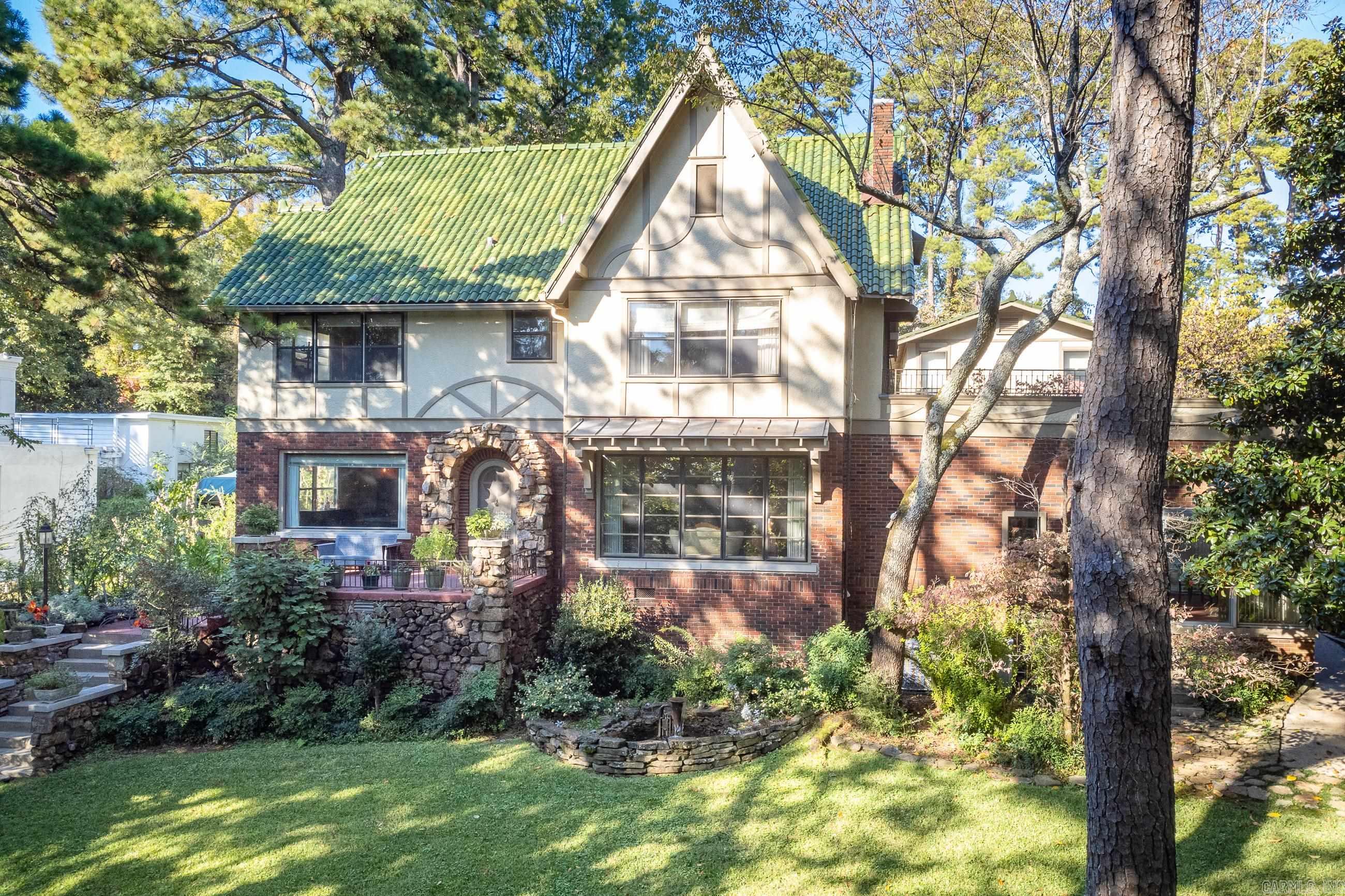 Quintessential English Revival Style home in Hillcrest sits in a park-like setting on .64 of an acre with a river view from the primary bedroom.  This historic home once served as the Governors residence for several years in the 1940's.  This home boasts arched doorways, arched french doors throughout and original hardwoods. All bedrooms are located upstairs with a fully floored attic space for storage or potential additional rooms.  Beautiful landscaping includes a naturalistic garden design with two ponds and charming decorative elements.  You will find a one car folly with screened-in porch at the rear of the property with plumbing for potential guest house if desired. A two car garage with an additional 644' of living space above (not counted in the sq. footage). This house was originally built with the front of the house facing Lee St which never was extended as planned.    Agents see remarks
