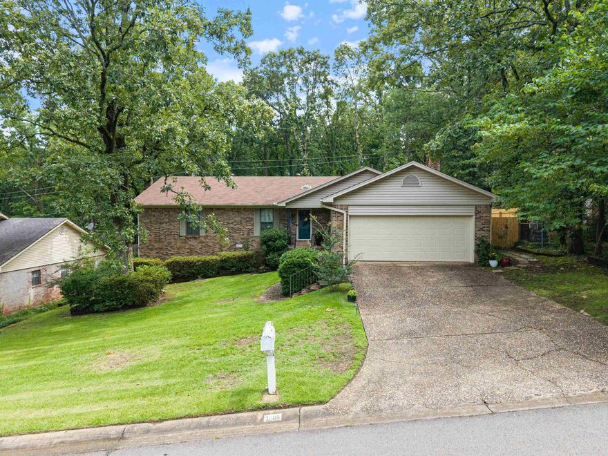 Charming one-level home featuring 3 bedrooms and 2 bathrooms . Open-concept living and dining area is highlighted by vaulted ceilings in living room,  skylights in the foyer and living room, and  site-built wood-burning fireplace that adds warmth and character. Bright sunroom opens to  private backyard leading to green space and  featuring a quaint patio with hot tub!  The home also includes a spacious primary suite with a built-in vanity and a large walk-in closet. Additional features include a large unfinished basement with both interior and exterior access and a two-car garage.*Sunroom is included in sq footage (140.69 sq ft) Agents Please see remarks