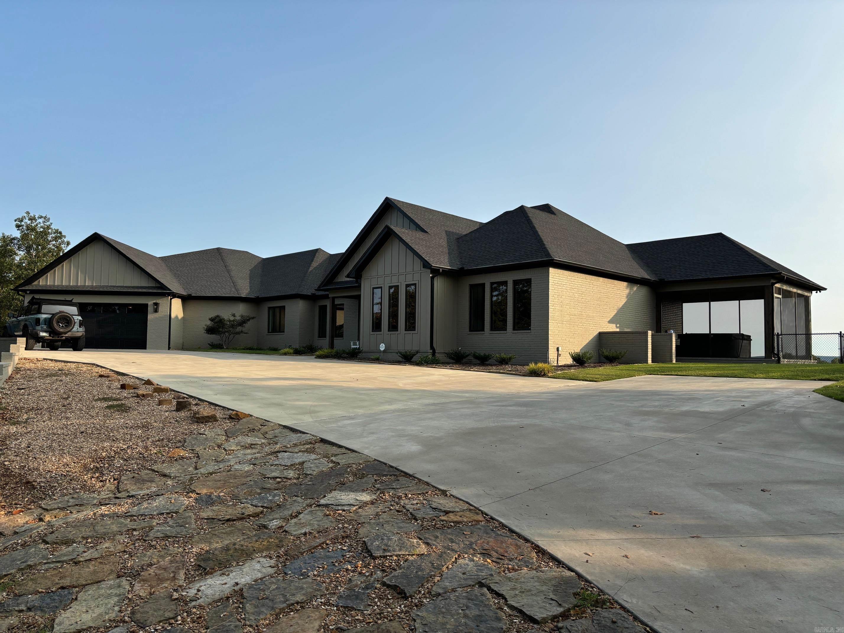 You'll absolutely love this beautiful, contemporary home nestled on the top of the ridge in the SW Conway/NW Mayflower area just minutes from Walmart in Conway and I-40 in Mayflower. The open floorplan has a mid-room fireplace that divides the great room and kitchen/dining area. The great room has a 20' cathedral ceiling with wood beam accents and there are 10' ceilings throughout the rest of the home. The kitchen/dining area is immaculately adorned with Brazilian marble countertops, a large island bar, a gas cook stove, and picturesque windows across the back that give way to a beautiful vista view to the south. There's a huge closet in the primary bedroom, exquisite primary bathroom, a media room, office/library, playroom, tankless water heater, food pantry, large safe room, oversized 3 car garage w/ front & back doors, covered patio, screened porch with jetted hot tub, flower beds, flood lights, sprinkler system, whole house generator, keypad-gated entrance all on 40 tree-covered acres with a view of the Arkansas River and Pinnacle Mountain. Enjoy the beautiful sunrises and sunsets from your own little slice of heaven. This home is a must see!