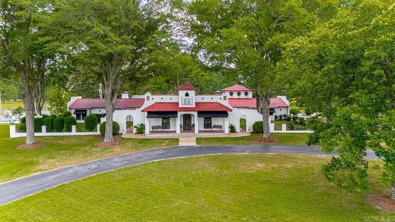 Country Living At Its Finest with City Convenience!!! Amenities Include: Approximately 5221 Square Feet, 4 Bedrooms, 6 Bathrooms, Large Living Room and Separate Formal Living Room, Living/Dining Combo, Large Kitchen with Island, (Gas Range, Double Wall Ovens, Microwave, Trash Compactor, Ice Machine ) Spacious Primary Bedroom with Sitting Area and Separate Sitting Area, Primary Bathroom has Jetted Tub and Stand Alone Shower, Walk-In Closets, All other Bedrooms are spacious with own Bathrooms, Sunroom in Second Level with Panoramic Views of Property, Tile Floors throughout Home, Laundry Room with Sink, 3 Car Garage, Front Sitting Porch, Courtyards with extra Landscaping, Inground Swimming Pool, Tennis Court, 3 Horse Barns with Stalls and Paddack Areas, 50' x 80' Shop/Equipment Storage Building, 1456 Square Feet Manufactured Home, 141 Acres of Pasture scattered with Mature Hardwood Trees, Property is fenced and cross fenced, Horse Round Pen Riding Arena, Cattle Pens for working cows, Creek, Ponds, Bryant Schools, and Much More... Very unique property and a rare find.. Truly a Custom Immaculate Home... A Must See...