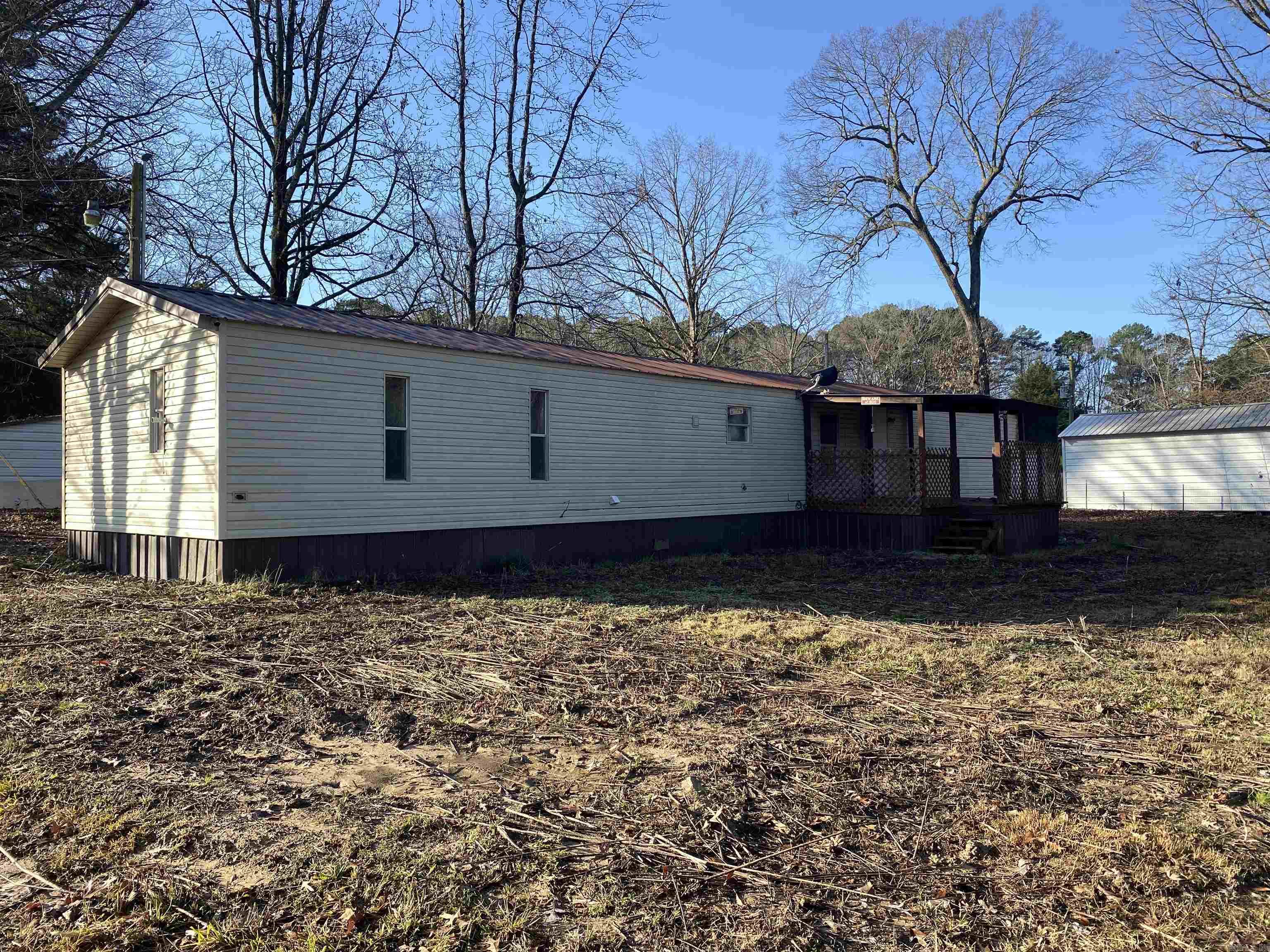 Calling all investors and first time homebuyers! This mobile home has just received a huge interior face lift, to include: new paint, fixtures, appliances, flooring and cabinetry and more. Not only do you get the home, but it also comes with two fixer upper storage buildings for all of your storage needs and outdoor toys. Call the listing agent to see it before it is gone!