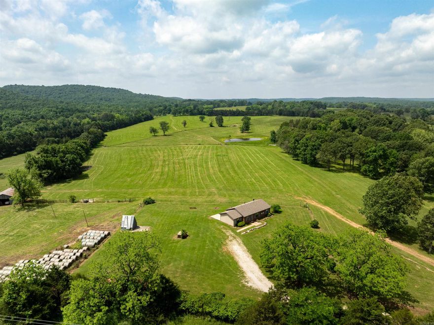 Farm with Breathtaking Views, Springs, Ponds & Multiple Home Sites – 145 +/- Acres  From the moment you pull onto this beautiful farm, you’re greeted with stunning views from the brick home, perfectly situated at the front of the property. The home offers approx. 1,161 sq ft with a newer roof and HVAC system (less than 2 years old). Built on a concrete slab, it features a cozy layout, back patio, and is move-in ready with just a touch of TLC.  Utilities: Grange Calamine water, North Arkansas Electric, and fiber internet already in place! Spring-fed Option: Property was once hooked to a spring, still flowing strong—offering the option to switch to spring water if desired.  Land Features:  Fenced & cross-fenced with hay fields  2 ponds + 2 live springs  Working cattle corral  Frontage on Highway 354 (paved) & Shiloh Rd (gravel)  Bonus Homesite: On the backside, there's a separate setup ready for a second home, mobile, or modular—ideal for multi-family livingwith privacy!  This land is truly turnkey for cattle, ready for horses, and could easily be adapted for sheep or goats. A versatile farmin an excellent location just outside Ash Flat, Arkansas—perfect for a family!