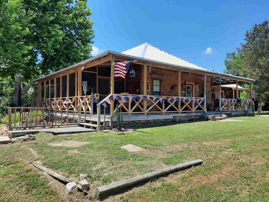 This is a turnkey business that is thriving and growing.  Nightly rentals, with-in easy walking distance of the Famous Court Square, music, shopping and restaurants.  This charming property offers 4 suites, 4 baths,  the Lazy Racoon suite offers 2 bedrooms, 1 bath, Kitchen, living room with queen sofa bed, River Rock Refuge offers a king bed with a trundle pull out, and kitchenette, other two suites offer king beds with kitchenettes, all suites can adjoin to accommodate a large family get-together or conferences, complimentary picnic and BBQ area, screened porch to set and relax or visit with friends.  Detached laundry/office, room to add cabins and expand. You have to see this beautiful property to appreciate all it has to offer.