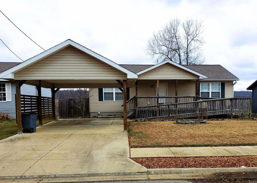 This fixer upper needs some TLC, but will make a great first home or investment property! The covered parking is a great bonus, and it has a great front porch. Inside the front door you will step into the living room that is open to the kitchen. The vaulted ceilings make the space feel really large!!   There is a storm shelter in the back yard. There are ramps on both the front and back porches, and the rooms are wheelchair accessible.
