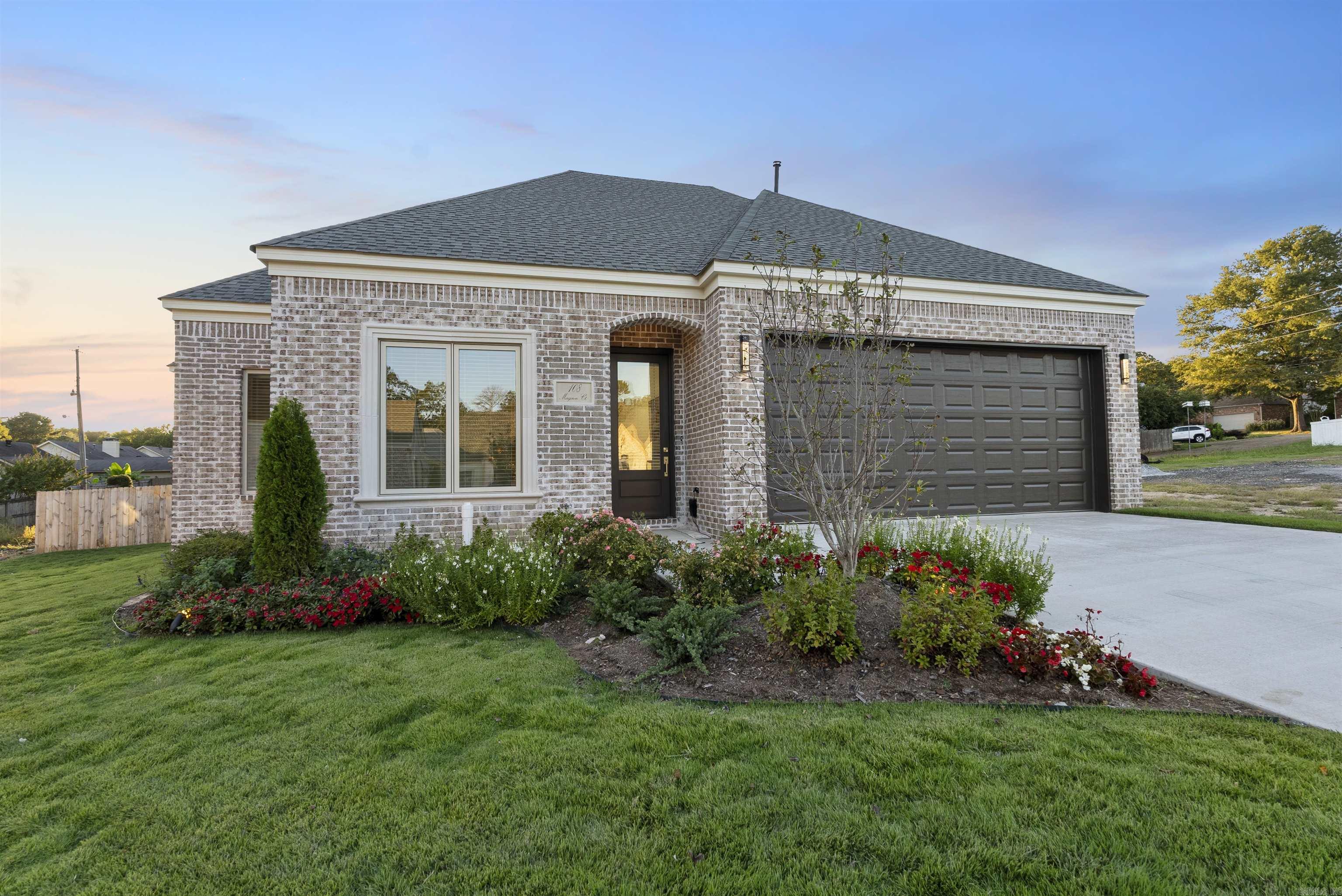 Welcome to Mergeron Court, an exclusive gated patio home community in the heart of West Little Rock located of Hinson Road. This new construction home, by Icon Homes, blends European-inspired architecture with modern design and craftsmanship. The one-story brick home features white oak hardwood floors, soaring ceilings, and expansive windows that fill the home with natural light. The open layout includes a spacious great room with LED fireplace, chef’s kitchen with GE Profile appliances, and dining area that opens to a private courtyard and fenced backyard. Two guest bedrooms share a hall bath, while the private primary suite offers a spa-like bathroom with freestanding tub, walk-in shower, dual sinks, and large closet. Additional highlights include professional landscaping with beautiful landscape lighting, sprinkler system, wooden privacy fence, custom designer light fixtures, window treatments, soft-close garage door, and more. The POA maintains the gate, streets, the Belvedere gazebo, and common area grounds for a relaxed carefree lifestyle.
