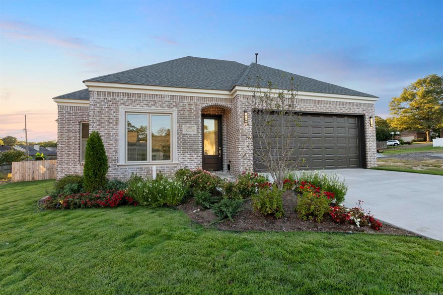 Welcome to Mergeron Court, an exclusive gated patio home community in the heart of West Little Rock located of Hinson Road. This new construction home, by Icon Homes, blends European-inspired architecture with modern design and craftsmanship. The one-story brick home features white oak hardwood floors, soaring ceilings, and expansive windows that fill the home with natural light. The open layout includes a spacious great room with LED fireplace, chef’s kitchen with GE Profile appliances, and dining area that opens to a private courtyard and fenced backyard. Two guest bedrooms share a hall bath, while the private primary suite offers a spa-like bathroom with freestanding tub, walk-in shower, dual sinks, and large closet. Additional highlights include professional landscaping with beautiful landscape lighting, sprinkler system, wooden privacy fence, custom designer light fixtures, window treatments, soft-close garage door, and more. The POA maintains the gate, streets, the Belvedere gazebo, and common area grounds for a relaxed carefree lifestyle.