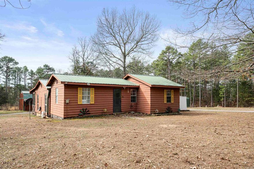 Charming 2 bedroom, 2 bathroom cabin-style home situated on approximately 1.4 acres in Shirley, Arkansas. This 1,248 sq ft home built in 2003 offers a peaceful wooded setting with a large screened-in back deck perfect for relaxing and enjoying the quiet surroundings and local wildlife. The property features a paved circle driveway, carport, shop building, and additional storage shed, providing plenty of space for tools, hobbies, or outdoor equipment. Located just minutes from Greers Ferry Lake and a nearby boat ramp, this property would make a great full-time residence, weekend getaway, or potential short-term rental. Inside you’ll find new LVP flooring, fresh interior paint, updated interior doors and trim, tiled bathrooms with updated toilets, and charming vintage stained-glass light fixtures that add character to the home. Recent updates include a new water heater installed in 2025, septic tank cleaned in 2024, plumbing updates, mini-split units, French drain, deck improvements, exterior paint updates, and general property maintenance. Enjoy the privacy of country living while still being conveniently close to the lake and outdoor recreation.