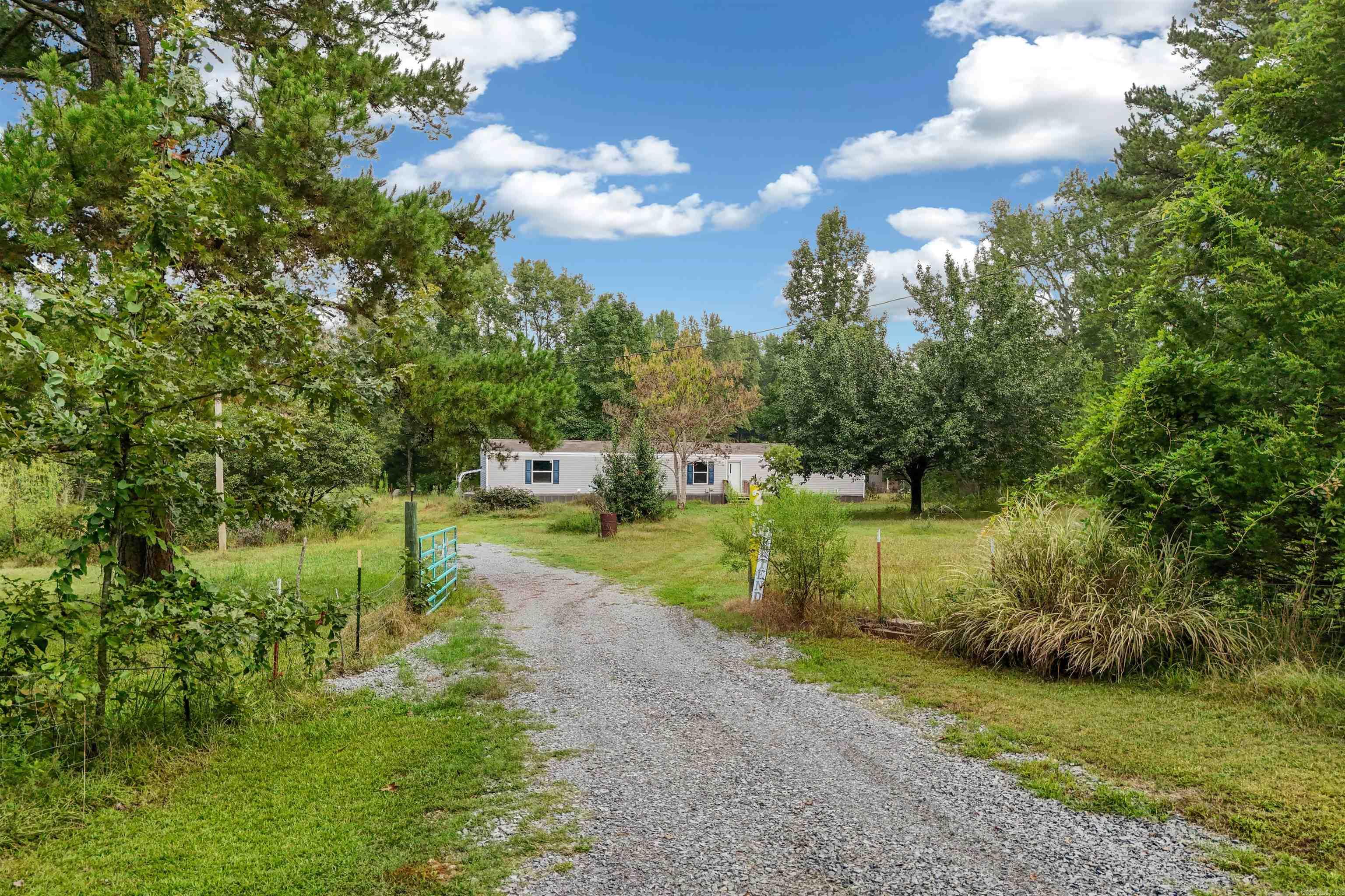 3-year-old immaculately maintained single wide mobile home on a level nearly 4-acre lot in the Vilonia countryside. Gated driveway and the home sits back off the road with plenty of room for a shop, pool, and large backyard gatherings.