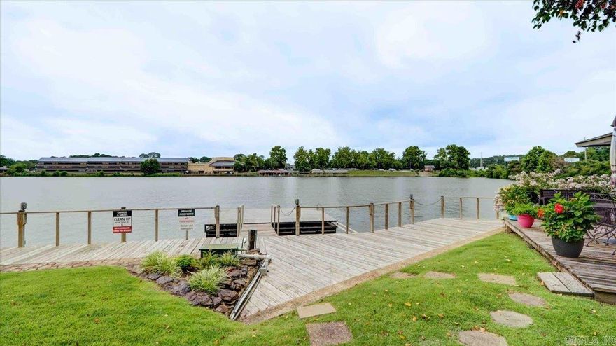 Welcome to this lovely walk-in level unit boasting stunning lake views on beautiful Lake Hamilton! With two (2) spacious bedrooms and two (2) full baths, this condo offers both comfort and convenience. The primary bedroom includes a fireplace for added relaxation. The open living and dining area is designed for seamless living, highlighted by an electric log fireplace that adds warmth and charm for cozy evenings. The kitchen is efficiently laid out, providing all you need for meal preparation and entertaining with a breakfast bar that completes the convenience.  Step outside to your roomy deck and enjoy the beautiful views! Boardwalk, swim dock, and pool, are all just a few steps away from your door. Whether you’re looking for a serene retreat or a vibrant spot for hosting friends and family, don't miss the chance to own a piece of paradise on Lake Hamilton! Some furnishings available for additional price.