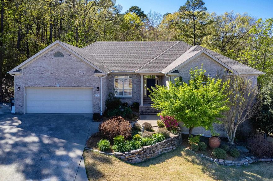 Beautifully updated Chenal home in a cul-de-sac w/ wooded green space behind for privacy. Kitchen recently updated with new tile, backsplash, paint, fixtures, hardware & walk-in pantry; Large living area with double-sided fireplace, vaulted ceiling, and wall of windows with a gorgeous wooded view; hardwood floors throughout main level including bedrooms; primary bath also recently updated with a gorgeous tile shower and soaker tub, quartz counters, paint, fixtures, and hardware. Downstairs area features a bonus/game room with a wet bar, 1 BR/1 full bath, that would make a great in-law quarters. Also has an additional office with a cedar closet PLUS a storage room/workshop with outside access to a fenced area of the backyard and beautiful wooded area. Bonus features include a sprinkler system, central vacuum system, plantation shutters, oversized garage and parking pad for an extra car. Main level HVAC unit is new. Agents, see remarks.