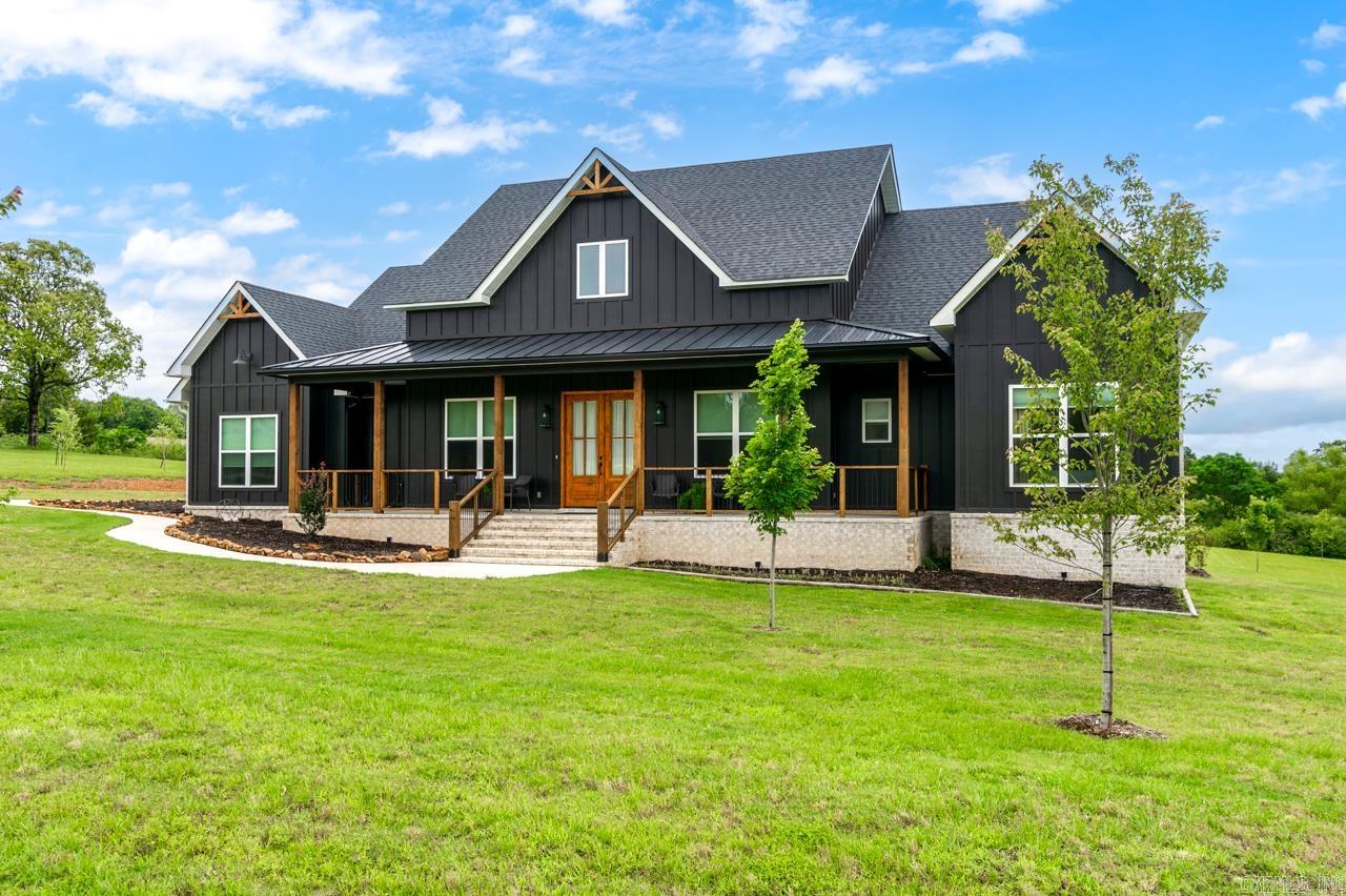 Welcome to 7 Pine Shadow Drive in Woodridge Sub Greenbrier! This modern farmhouse home offers 2432 sq.ft. of thoughtfully designed living space on 2.17 acres! Inside- enjoy the nice wood ceramic tile throughout the home, a gourmet kitchen with island and floating shelves. The primary suite features a spa-like retreat with a tiled walk in shower, soaking tub and large built in closet. Not to mention all of the bedrooms are of nice size with nice size closets. There is an abundance of storage throughout the home. A large patio to enjoy your evenings on. Beautiful upgraded fixtures, extra thick granite through out, beautiuful ceilings with lots of detail. A three car garage for storage galore! Call today and check it out! This is one not too miss.