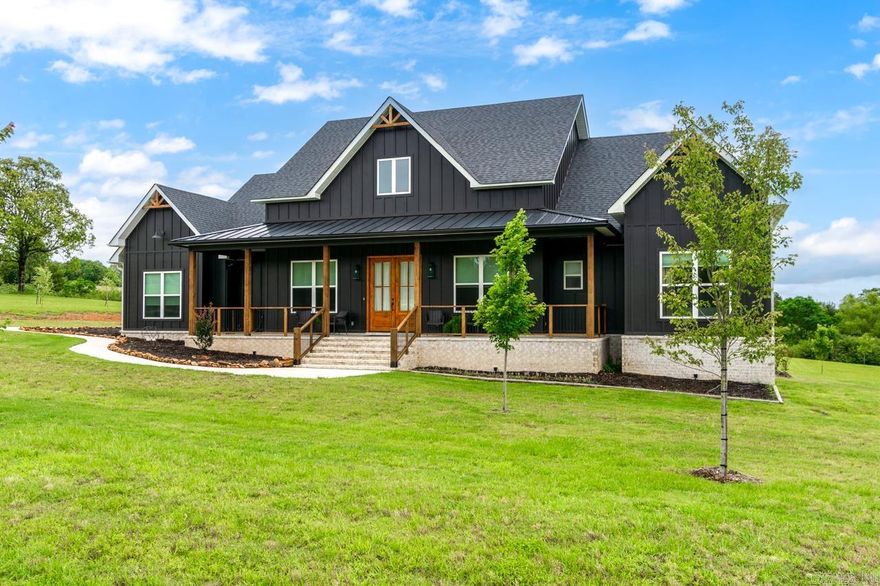 Welcome to 7 Pine Shadow Drive in Woodridge Sub Greenbrier! This modern farmhouse home offers 2432 sq.ft. of thoughtfully designed living space on 2.17 acres! Inside- enjoy the nice wood ceramic tile throughout the home, a gourmet kitchen with island and floating shelves. The primary suite features a spa-like retreat with a tiled walk in shower, soaking tub and large built in closet. A large patio to enjoy your evenings on. Beautiful upgraded fixtures, extra thick granite through out, beautiuful ceilings with lots of detail. A three car garage for storage galore! Seller paid  for upgrades outside of closing! Ceramic wood flooring.  upgraded lighting, upgraded fan fixtures, upgraded granite throughout, backsplash in kitchen. A company planted 23 trees and sodded back and sides. Impact shingles were also installed.