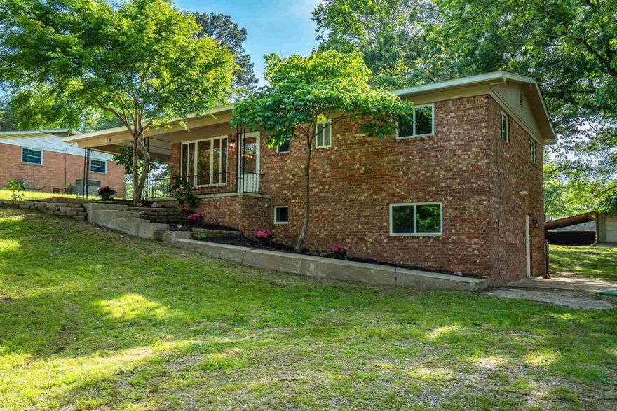 Welcome to this beautifully reimagined Lake Hamilton School stunner!  With 4 Bedrooms and 3 full baths, this property has been completely remodeled from the studs including updates to electrical and plumbing to modern standards offering peace of mind for years to come.  Every inch of this home with meticulous attention to detail and modern design has been thoughtfully updated offering the perfect blend of style, comfort, and functionality.  Step into the expansive family room where soaring ceilings and abundant natural light create a warm and inviting atmosphere - perfect for gatherings or relaxing evenings by the fireplace. The custom wet bar adds a touch of luxury and convenience for entertaining. The open-concept layout flows seamlessly into the brand-new kitchen featuring high-end finishes, new cabinetry ,sleek. countertops, and new appliances.  Each of the bathrooms has been fully renovated with designer touches and finishes. Enjoy added convenience with 2 separate laundry rooms, ideal for larger families or multi-generational living.  With four generously sized bedrooms, there's plenty of room for everyone to have their own space.