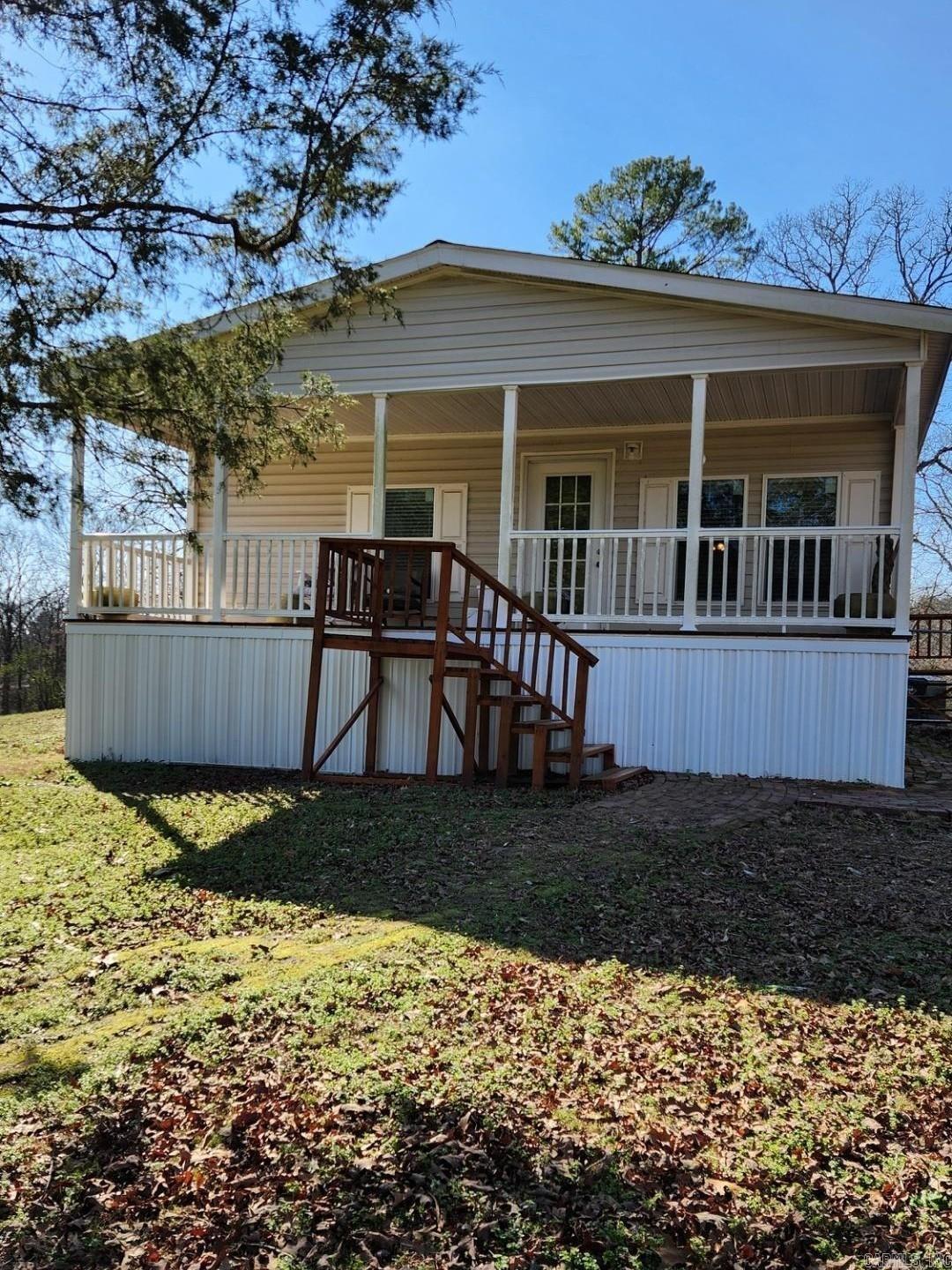 Sitting on a hilltop up a private driveway, this home feels tucked away and offers privacy along with awesome views. Covered front porch makes for relaxing and soaking in those views! Check out the gazebo in the front yard! This is a 2021 All Electric -double wide-manufactured home. Sitting on 5 acres, with 3 of those fenced in with chain link. 3 bedrooms, and 2 baths, with a detached garage/workshop, with an additional large storage shed, perfect for storing tractor, mower, or boats. The master suite has a large walk in closet, with a master bath that has an awesome step in shower. Both spare bedrooms, also, have walk in closets. Refrigerator, washer & dryer stay. Brand new dishwasher just installed. Hurry to see this one!
