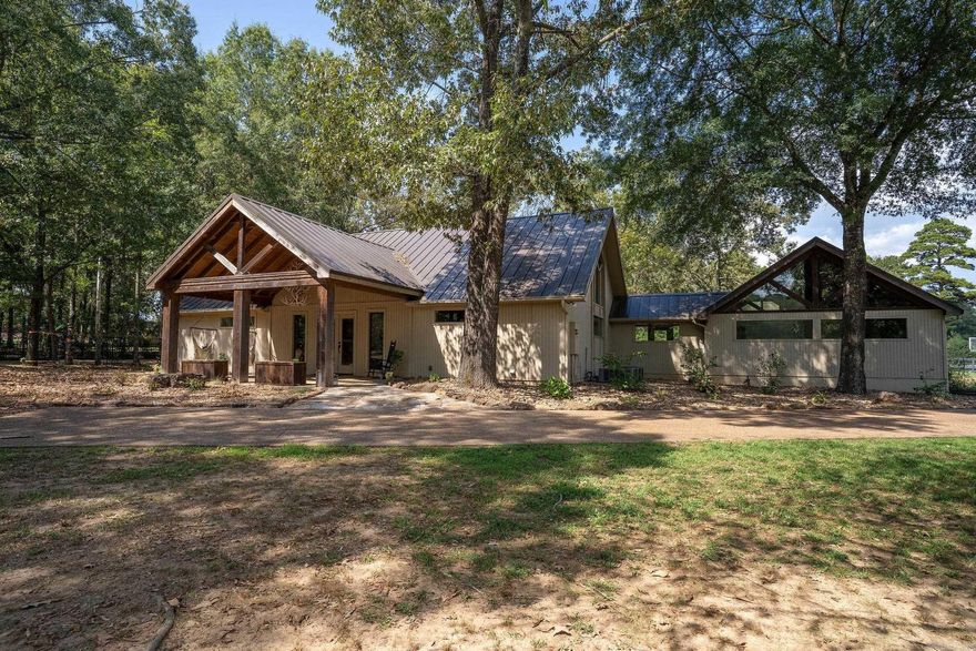 custom home on 2 unrestricted acres just 2 miles from Eden Isle Marina and Greers Ferry Lake, The floor plan encompasses 3 roomy bedrooms, and 3 and 1/2  bathrooms, a private balcony area, giving you just under 3,000 sf of spacious elegance! The interior includes custom valulted wood ceilings, wood flooring, two gas fire places, one in the master bedroom, The generously proportioned interior flows effortlessly from the open-plan living space to the multiple private patios perfect for family gatherings and entertaining. back patio is real stone and includes a natural stone dry stacked fire place, and a built in gas grill and sink, covered front porch. your dogs will love the 2 acres that is completely fenced with rod iron fencing and a security gate, see virtural tour and floor plan in pictures