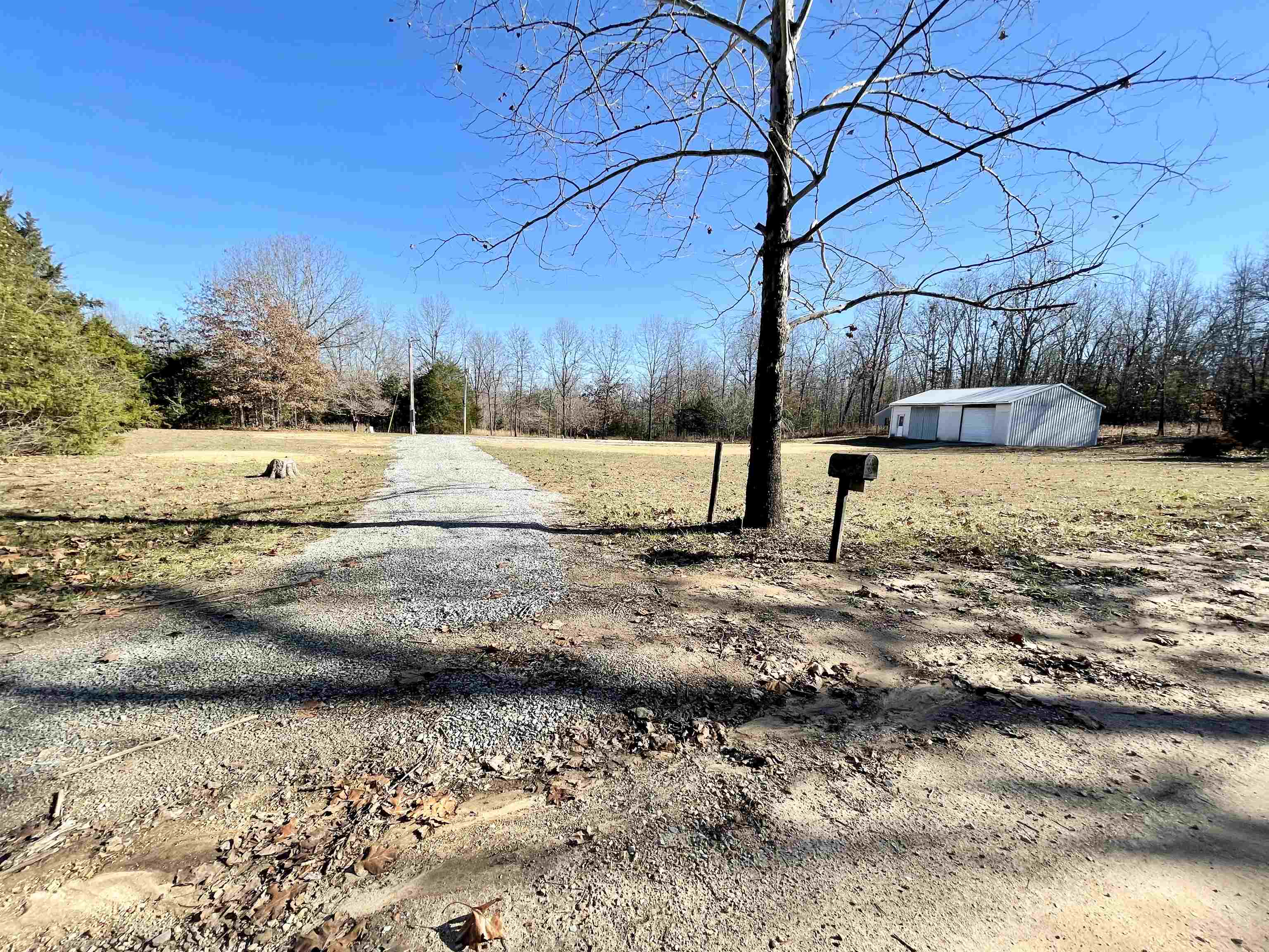 ACREAGE/ELECTRIC/COUNTY WATER WITH METER IN PLACE/SEPTIC TANK ... All on 3.8 Acres +/- in the Ozarks of North Central Arkansas in Fulton County. Ready to build that new dream home in a quiet area not far from Glencoe. Chatted driveway into the property. The land is a mix of open areas and woods with apple trees and a stocked pond! 28x40 Shop with concrete floors with an enclosed sheetrocked and insulated room to live in. RV hook up at the electric pole. Overhead electric door in shop. Plenty of room for some pasture and a garden. The land is level to gently rolling with various oaks which include white oaks and a few cedars. White oak trees are well known to attract deer as they love the acorns. Make this spot your new home which is within 10 miles of Ash Flat, Horseshoe Bend, and Salem for all your amenities. Mtn Home, Batesville, and West Plains MO are all around 60 minutes drive.