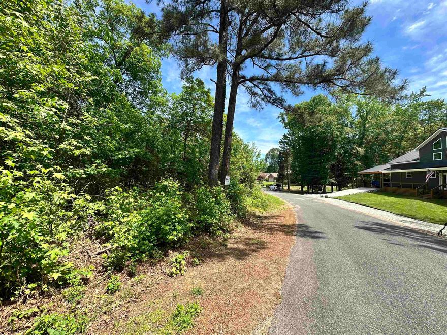 Beautiful, corner lot with views of Lake Catherine! Wooded land perfect for building your dream home.  Amenities include an 18 Hole PGA sanctioned golf course, clubhouse with restaurant, banquet room, Olympic size swimming pool, and tennis/pickleball courts.