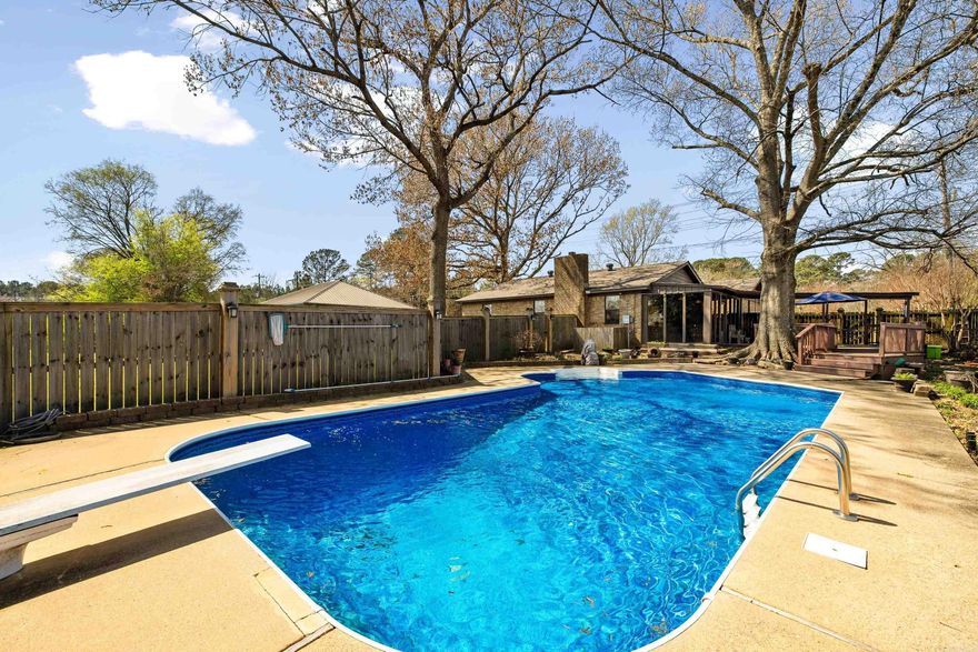 ONE LEVEL HOME IN SALEM ON ACREAGE WITH A POOL! Rare opportunity to own a private, in-town retreat on a full acre! This 4 bed, 2 bath home offers an updated kitchen with breakfast bar that opens to a spacious dining area. The inviting living room features vaulted ceilings with painted beams, built-ins, wood floors, and a wood-burning fireplace. Enjoy the sunroom year-round, plus great storage throughout, including a huge walk-in closet. The backyard is perfect for entertaining with a pool, large deck, and covered porch. Includes 2-car carport, whole-house generator, storm cellar, and a 1-year-old roof. Located in Bryant School District!