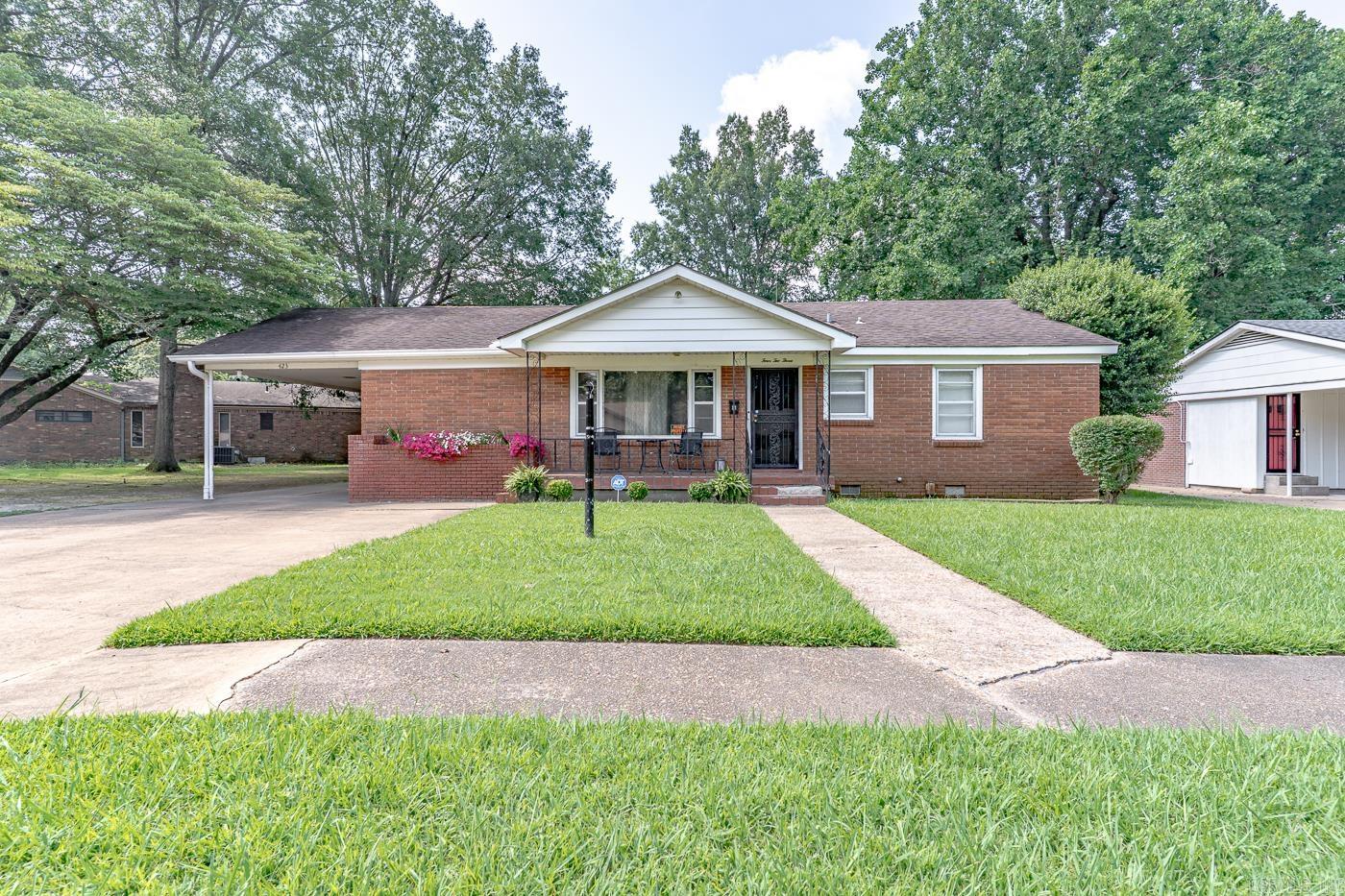 Welcome to market this charming well maintained home located in the heart of Forrest City. This home features 3 spacious bedrooms 1.5 updated bathrooms and is a perfect space for gathering as it offers a formal living room, separate dining room, and a large den with a gas fireplace that flows seamlessly to a traditional eat-in kitchen. Kitchen offers ample upper & lower raised panel cabinetry, stainless steel dishwasher, electric range stove, side by side refrigerator and a double sink. Hardwood flooring throughout and neutral earth tones which provides a blank canvas for any design style. Brick home sits on a leveled and manicured fenced lot with a side & rear carport that leads to an attached shed. Powered detached 21x25 workshop provides additional space for storage, crafts, or garden enthusiasts. Home will also feature a brand new roof with archetectural shingles. HVAC 2017 Hot water tank 2022 Security system and cameras are leased do not stay. Call today to schedule your private tour.