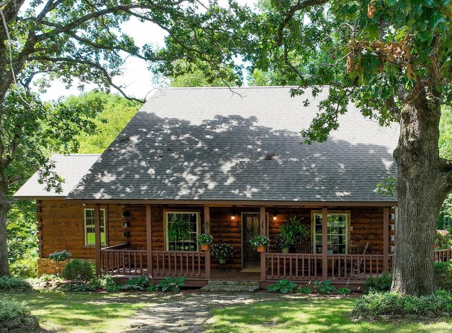 $30K Below Appraisal! Beautiful 3-bedroom, 2-bath log home on a gently sloping 1-acre lot in an established, well-maintained neighborhood just 4 miles from the Stone County Courthouse Square in Mountain View. Convenient to the White River and local amenities, this property offers a perfect blend of comfort, space, and natural beauty.  The upper level features solid hickory wood floors, a large great room with vaulted ceiling and cozy gas log fireplace, a spacious dining area, and a well-appointed kitchen. Also on this level are a generous bedroom, full bath with whirlpool tub, and an office area.  The walkout basement offers 9-foot ceilings, a second living area, full kitchen, two bedrooms, full bath, laundry room, a hobby/office space, and a private back porch—ideal for guests or extended family.  Enjoy outdoor living on the wrap-around porch surrounded by mature oak trees. The 30x40 garage/shop includes three bays, a built-in workbench, and a large loft for additional storage.  Built in 2006, this 2,612 sq ft home has been lovingly maintained. Both the house and shop received new roofs in 2024.  Don’t miss this rare opportunity to own a beautifully maintained home in the Ozarks!