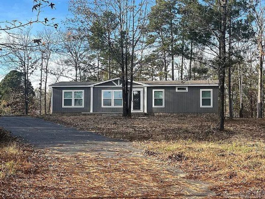 Brand new Clayton home situated on 1.38 acres, offering a peaceful country setting in a highly desirable area. This 3-bedroom, 2-bath split floor plan features a bright and open kitchen with stainless steel appliances, including the refrigerator, a spacious island, pantry, and adjoining dining area. A separate office provides the perfect space for working from home or additional flex use.  The private primary suite includes a relaxing soaker tub, separate shower, and double vanity. Exterior highlights include durable LP Smart siding with brick skirting around the perimeter, a covered concrete front porch, and paved driveway. Located in the Lake Hamilton School District and conveniently close to lakes, restaurants, shopping, and area amenities. This property offers the perfect combination of comfort, style, and location. Adjoining 1.62 acres also available for sale.