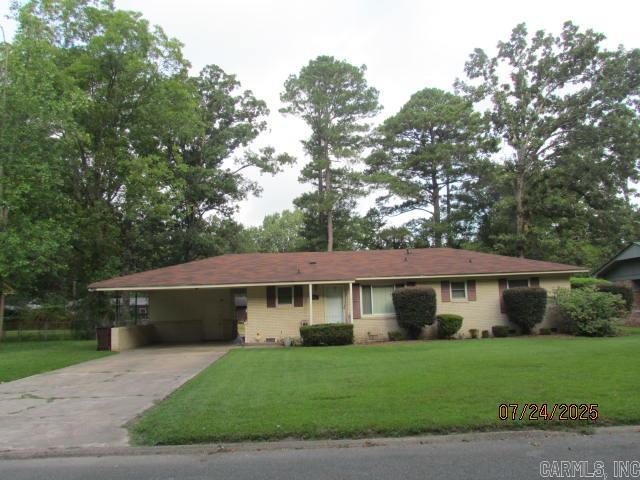 This lovely home has a Great location for families with Pecan Street being one of the widest streets in town making it good for families to ride bikes or just walking. Also the home is located Close to Anderson Elementary School and the exercise Park and also major employment, city amenities and sports complex. This beautiful home features original beautiful hardwood floors, living room, den/dining/kitchen combo with vinyl flooring, three bedrooms with large closets, master has a large walk-in closet, Hall bath is large with double sinks and shower over bathtub. Master bath features a walk-in shower and pedestal sink. The Laundry room is located in large storage room off carport. A storage building was moved from the large backyard and that is why there is a blank dirt spot. Back yard also has a Partial fence up and the other fencing with a double gate that was taken down to remove storage building will be left with property that can be reinstalled. Roof is 2 yrs old. New windows have been installed in the front and sides of the house, but not on the back of thee house. This home is just waiting for you and your family.